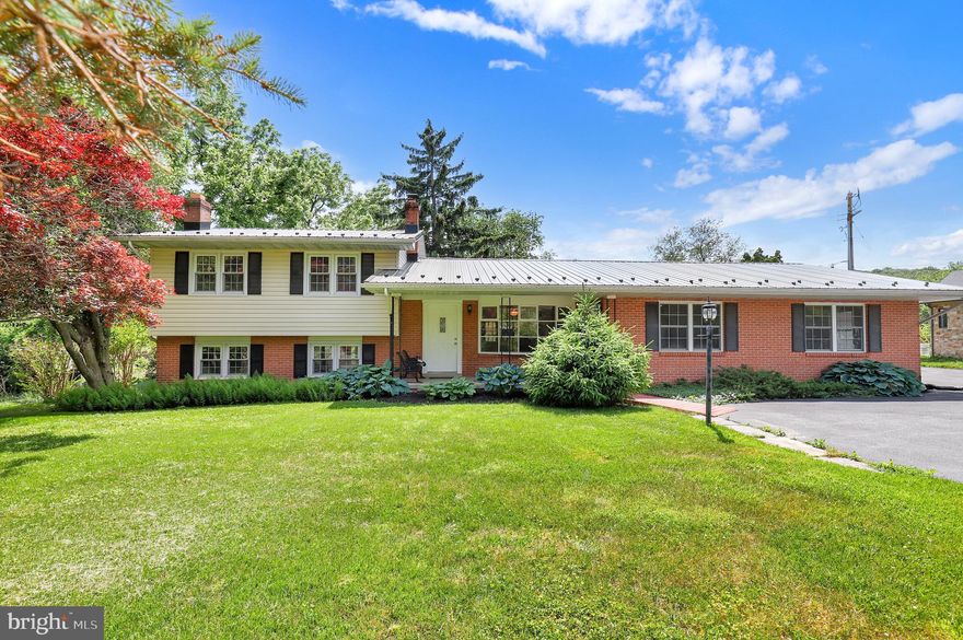 Welcome to this rare and hard-to-find property offering the perfect blend of privacy, flexibility, and multigenerational living. Tucked away on a quiet dead-end road and surrounded by peaceful views of trees and open fields, this unique home sits on a private .52-acre lot and features a true in-law suite with its own separate entrance — ideal for extended family, guests, private living quarters, house hacking or flexible lifestyle needs.   With 2,390 finished square feet, the home offers 4 bedrooms and 2.5 baths, including a permitted in-law suite complete with its own kitchen, spacious living area, large bedroom, and full bath. Fresh paint and new LVP flooring in the suite’s bedroom and living area create a clean, updated, move-in ready space. The main home features 3 bedrooms and 1.5 baths with comfortable living spaces filled with natural light and views of the surrounding countryside.  Enjoy quiet mornings from the wood deck off the primary bedroom overlooking the peaceful backyard. Additional highlights include a wood-burning fireplace, walkout lower level exit to backyard, an extra room on the lower level that could be used as another bedroom or office space, auxiliary wood furnace in basement and an oversized 2-car garage. Recent updates include a metal roof installed in 2023, new upper-level bedroom and bathroom doors, some newer appliances (range & dishwasher) and an updated bathroom vanity and shower/tub. Cooling for the main and upper levels is provided by a TRANE 1400XL system located in the attic, while electric baseboard heat serves the home throughout.  Offering privacy, flexibility, and country charm while still being convenient to Frederick shopping, dining, and commuter routes, this one-of-a-kind property is filled with potential and possibilities.