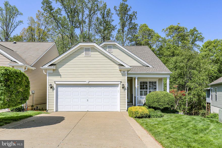 Welcome to this beautifully maintained "James model" home in the sought-after Del Webb Active Adult Community of Falls Run! Backing to serene woods and offering the perfect blend of comfort, privacy, and convenience, this home features 3 bedrooms, 3 full bathrooms, and a fully finished walk-out basement.

Step onto the front porch and inside to a bright center foyer that opens to a well-appointed kitchen with light cabinetry, sparkling appliances including a built-in microwave, flat-top downdraft cooktop, refrigerator with ice maker, and wall ovens. You'll love the abundance of counter space, pantry storage and cozy breakfast nook with views of the front yard.

The open-concept dining and family room is perfect for entertaining, with access to the screened porch overlooking the treetops—your own private retreat. Enjoy tranquil mornings and peaceful evenings with nature as your backdrop.

The spacious primary suite also enjoys woodland views and features a large walk-in closet and a private ensuite bath with dual vanities and a walk-in shower. At the front of the home, you'll find a versatile guest bedroom or home office/den adjacent to a full bathroom with a walk-in hydrotherapy tub—perfect for relaxation.

The main-level laundry room includes additional storage and leads to a two-car garage, complete with a built-in screen door for enjoying a natural cross-breeze.

Downstairs, the finished basement includes a third bedroom and full bath, ideal for overnight guests. The oversized Rec Room opens to a shaded ground-level patio, perfect for summer dining or quiet outdoor moments. A large utility/storage room ensures you’ll have plenty of space—no need to downsize!

Ideally located across from the community center, you’ll enjoy easy access to tennis and pickleball courts, guest parking, and all the resort-style amenities Falls Run has to offer. Take a short stroll to the clubhouse, where a full-time Lifestyle Director plans daily activities and events. Enjoy two swimming pools, billiards, fitness classes, lectures, and more—all supported by friendly concierge staff ready to welcome you home. Stop in and say Hello while you're touring this home and pick up a copy of the monthly activity calendar and gazette.

Don’t miss your chance to live the good life at 414 Bridgewater Circle. Schedule your private tour today!