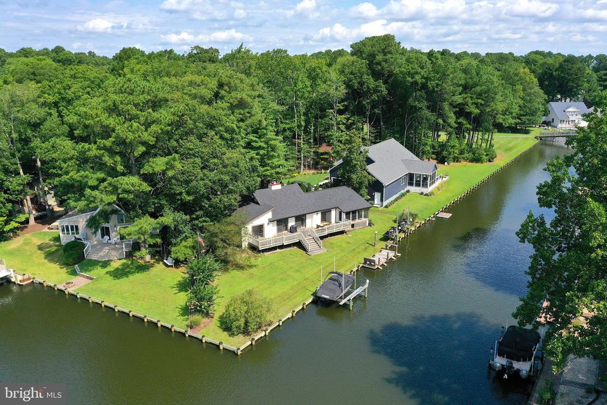 This stunning single-level home in Ocean Pines boasts a huge waterfront lot of approximately .43 acres with waterfront footage of roughly 140ft, situated at the end of a cul-de-sac. The property features 3 bedrooms, 2 baths, and a 1-car garage, making it the perfect size for year-round living or use as a vacation home. The home interior was remodeled in 2021 and a new heat pump installed in 2018. The living room has vaulted ceilings and offers beautiful views of the water. There is also a screened porch with canal view, perfect for relaxing and enjoying the scenery. For those who love water activities, this property was equipped with a new boat lift and 2 jet ski lifts in 2022 and there is a separate dock that is perfect for fishing or crabbing. Additionally, there is a large back deck and spacious back yard with awesome water views that provides plenty of space for entertaining or just enjoying the peaceful atmosphere. With LVP flooring throughout the house and a new roof installed in 2021, this property is move-in ready and offers a comfortable and stylish living space. Don't miss out on the opportunity to own this amazing waterfront property! Ocean Pines Amenities include year-round Indoor Pool, Outdoor Pools, Tennis & Pickle Ball Courts, Basketball Courts, Golf, Recreation/Community Center, Beach Club & Parking in Ocean City at 50th St., Yacht Club, Marina, Boat Ramp, and Much More. Come make this home all yours and enjoy all that the Ocean Pines community has to offer! *** Seller will review all offers after 10am 8/29/23