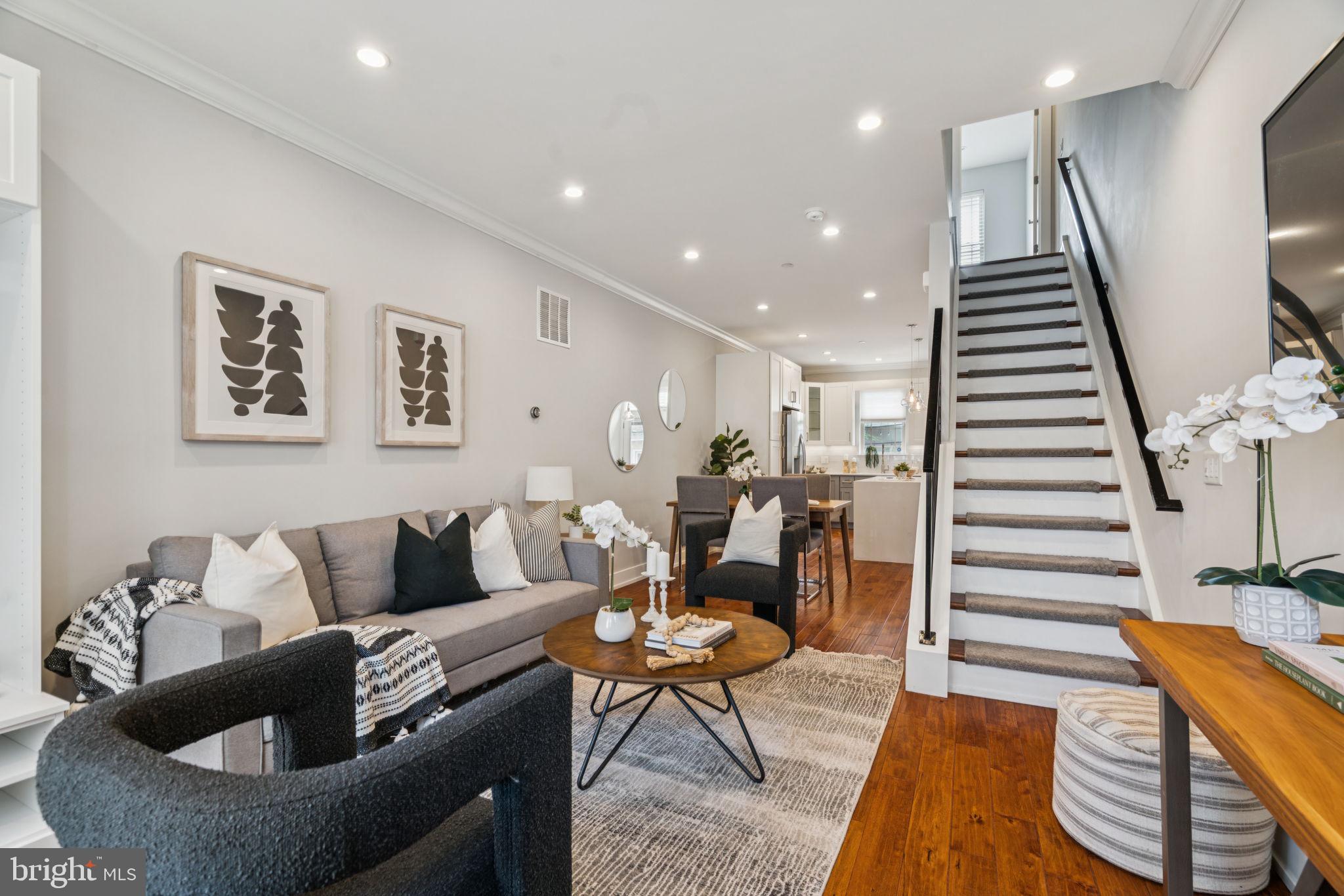Enjoy modern luxury in this 4 bedroom, 3 bathroom home with ROOF DECK, FINISHED LOWER LEVEL and REMAINING TAX ABATEMENT. Step into the gracious living and dining areas featuring gleaming hardwood floors, a perfect open layout and oversized windows that fill your space with an abundance of light. The chef’s kitchen showcases gorgeous soft-close cabinetry, stainless steel appliances and quartz countertops with waterfall island. A sunny patio off the kitchen is the perfect spot for grilling, morning coffee or gardening. Up the stairs are two large, bright bedrooms, a full bath with custom tile work and modern vanity, and a convenient laundry area. The top floor is dedicated to the oversized primary suite, offering an expansive bedroom with stunning views, a large walk-in closet and a serene bathroom complete with double vanity, 3-head oversized shower, and a soaking tub. Head up to the large roof deck to relax and entertain in style with breathtaking city skyline views. The finished lower level hosts a private additional bedroom with high ceilings and adjacent chic full bathroom. There is excellent storage on this level and throughout the home. The 4 years remaining full tax abatement will save you nearly as much as would the city’s current 10 year tax abatement. With a great central location - near beloved neighborhood coffee shops, bars and restaurants, recreation, a brand new ALDI and CVS, and a quick walk to Rittenhouse Square, University City, business district and all hospitals and universities - this home offers the perfect blend of luxury, comfort, and convenience.