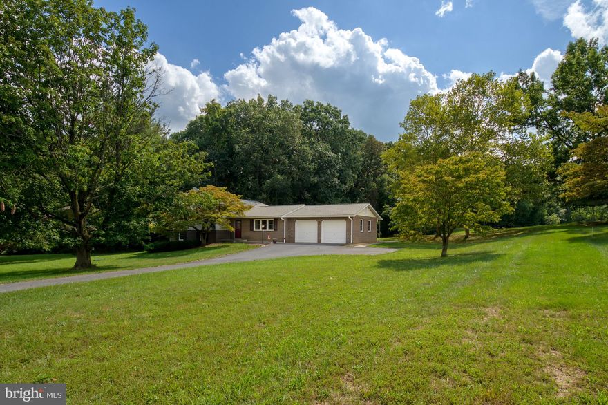 Gently lived in 4 level Split on .96 Acre lot with beautiful views from every window!  Hardwood floors on main and upper level.  Open concept floor plan with entrances on front,  back and side.   4 BD, 2 1/2 Baths.
Both Primary and hall bath have been updated to include walk in shower in Primary and soaking tub in hall bath.  Primary BR has a large walk in closet.  Storage galore! Recent roof, Septic replaced in 2012 (tank and drain field)  Hot Water heater 2021, water pressure tank 2022.  Ceiling fans throughout the home.  Large deck  (14 X 24) off kitchen for summer entertainment.  Cozy brick front fireplace in family room.  Vinyl siding with brick to grade. Super lot for your enjoyment!