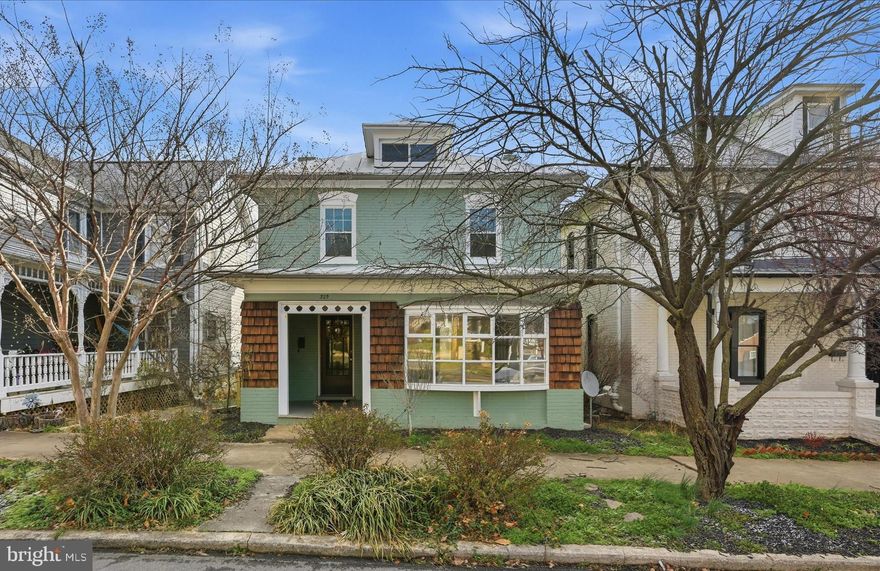 1920's historic home just blocks from restaurants, theater, library, parks, and the farmers market, offering original character and flexible living space. Acorn accent trim and a stained-glass window make a memorable first impression on the front porch. Inside, original hardwood floors, natural light, and spacious rooms create a warm, functional layout. The large dining room extends the kitchen’s entertaining potential, while the sunroom with brick paver flooring works well as an office, library, or studio. Upstairs features three generously sized bedrooms and a spacious full bath. The walk-up attic offers storage and future potential. A large deck overlooks the private backyard with raised beds, a chicken coop, fencing, a shed, and potential for off-street parking. The basement provides added workshop and storage space. A home like this doesn't come available often. Schedule your showing today!