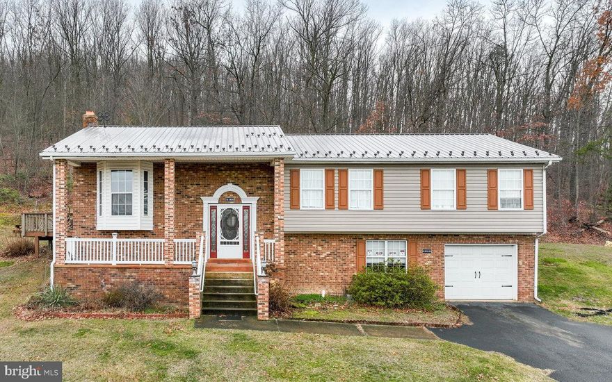 Welcome to this wonderfully maintained Split-Level in the Town of Stanley, VA. Here you'll find a beautifully remodeled kitchen with new appliances, granite countertops, and tiled backsplash. Large living area with a  bay window and dining room that are just off of the kitchen. Down the hall, there is a remodeled full bath, two bedrooms and a linen closet. Spacious primary bedroom with a full bath attached and large walk-in closet. The downstairs has an additional living area with a woodstove, a bedroom, half bath that has the hookup to easily add a shower/bath, and large closet. The garage and workspace are also on the lower level, along with a laundry room. Out back, there is a wraparound deck with a mountain view that is simply breathtaking. Enjoy these views from the deck or gazebo with a cup of coffee in the morning. The backyard meets the woods for some extra peace and quiet. In town limits for the ease of town water, sewer, and trash pickup, yet far enough away you'd never guess you were in town. Come see this stunning property today and make it yours!