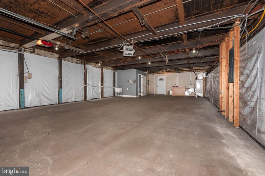 LARGE GARAGE IN A PRIME COMMERCIAL BUILDING - IDEAL FOR A SMALL BUSINESS LOOKING FOR STORAGE/WAREHOUSE SPACE!  This space has an electric garage door which opens to the large space that has water access, a half bath, & overhead heating.  Building is located minutes from 695 & 95.  Utilities included!