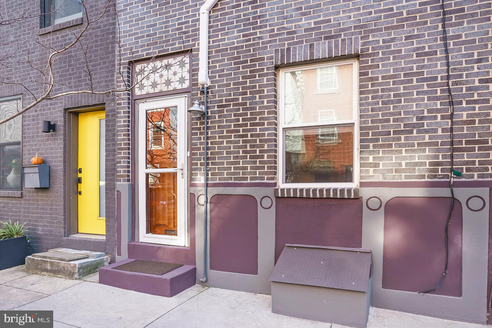 Location, location, location!  This artistically updated and unique 3 Bedroom townhome is located just steps away from the Piazza and North 2nd Street, which puts you within a short walk to the best of what Northern Liberties has to offer!  This remarkable home is best seen in person to be appreciated.  The front door has a custom digitally printed ceramic tile transom above and enters into the spacious and warm living room and dining area, which features a full wall of exposed brick on your left, custom-crafted recessed framed exposed floor joists on the ceiling, crown molding, custom high-efficient radiator covers, and wainscoting.  There are stunning original pine random-width floors throughout the entire home.  A wall-cut-out picture window looks into the kitchen from the living area which creates an open concept feeling.  The very large eat-in kitchen features plenty of custom solid wood white cabinetry, leathered granite countertops, a subway tile backsplash with inlays, crown molding, an oversized stainless steel farm sink, recessed lights, extra high wainscoting, and stainless steel appliances including a built-in microwave, gas oven/range, refrigerator, and dishwasher.  A door from the kitchen leads to the English garden-style private brick back patio space with a tree for shade and perennials in the planter box.  There is a turned metal staircase from the patio that leads to the 2nd-floor roof deck.  On the second floor, you will find the sizable main bedroom and the spacious bathroom that has a granite-topped custom double vanity, pendant lights, subway tile wainscoting and tub surround, marble flooring, recessed lights, and a linen storage area.  Completing the second floor is a door that leads to the recently recoated and sealed (late 2020/early 2021) outdoor roof deck with matching porch furniture that is made of the same solid hardwood.  The third floor has two additional bedrooms with ceiling fans and tasteful paint colors.  The basement is clean, a great place for storage, and is where the laundry area is located.  Other features of this unique and outstanding home include a completely replaced facade with all new Yankee Hill Dark Iron Spot bricks (2019), all new windows in the front of the house and kitchen, and other upgrades throughout.  The location can’t be beat!  A block and half away from Liberty Lands Park which is a 2-acre park with a community garden, playground, and other amenities. Don’t miss your opportunity, schedule a showing today!
