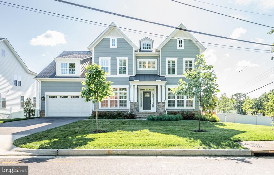 Located just minutes from Belle Haven Country Club, Old Town Alexandria, the Potomac River, and the GW Parkway, this incredible Chapman model built by Evergreene Homes in 2023 features more than 9000 square feet on three levels and includes more than $450,000 of options and upgrades. The hardiplank with stone craftsman style home welcomes you with a charming front porch and grand foyer.  The lot is beautifully landscaped with an irrigation system.  There are wide panel hardwood floors throughout the main level and dual staircases. Working from home is easy and enjoyable with the main study located in the front of the home where you can enjoy peace and quiet away from the main living area in the back of the home. There is a formal dining room with a butler passageway with two beverage refrigerators. The gourmet kitchen is sure to impress with white painted maple cabinets featuring soft close cabinets and drawers and quartz countertops providing a sleek and elegant feel. The kitchen also features an enormous island with gracious seating and extra storage with a huge butler’s pantry. The additional morning room provides access to a low maintenance deck with stairs to a fenced in backyard.  Designed with the family in mind, the great room includes a gas fireplace and a separate wall for the entertainment center, as well as an impressive, coffered ceiling detail. The mud room including built in lockers and cubbies provide ample space for your kid’s shoes, backpacks, and sports equipment. A guest suite with a closet and full private bath on the main level can also be used as a private second office. On the upper level, the huge owner’s suite with sitting room and oversized walk-in closets.  The owner’s spa bathroom features a large frameless shower, a tub, as well as ample storage with dual sinks and vanities. Each of the three additional upper-level bedrooms are roomy with walk-in closets and on-suite bathrooms. The laundry room is located upstairs with cabinets, sink, and counters for working space.  The basement features a huge finished recreational room, exercise room, media room, and bedroom with full bathroom. There are two storage rooms.  This amazing home includes quality features such as white Plantation Shutters throughout, humidifier, electronic air cleaner, abundant recessed lighting, best in class 10 year transferable Builders Warranty, 2X6 upgraded framing, thermal insulation, and pest tubes in the exterior walls and so much more.  Come for a tour and fall in love!