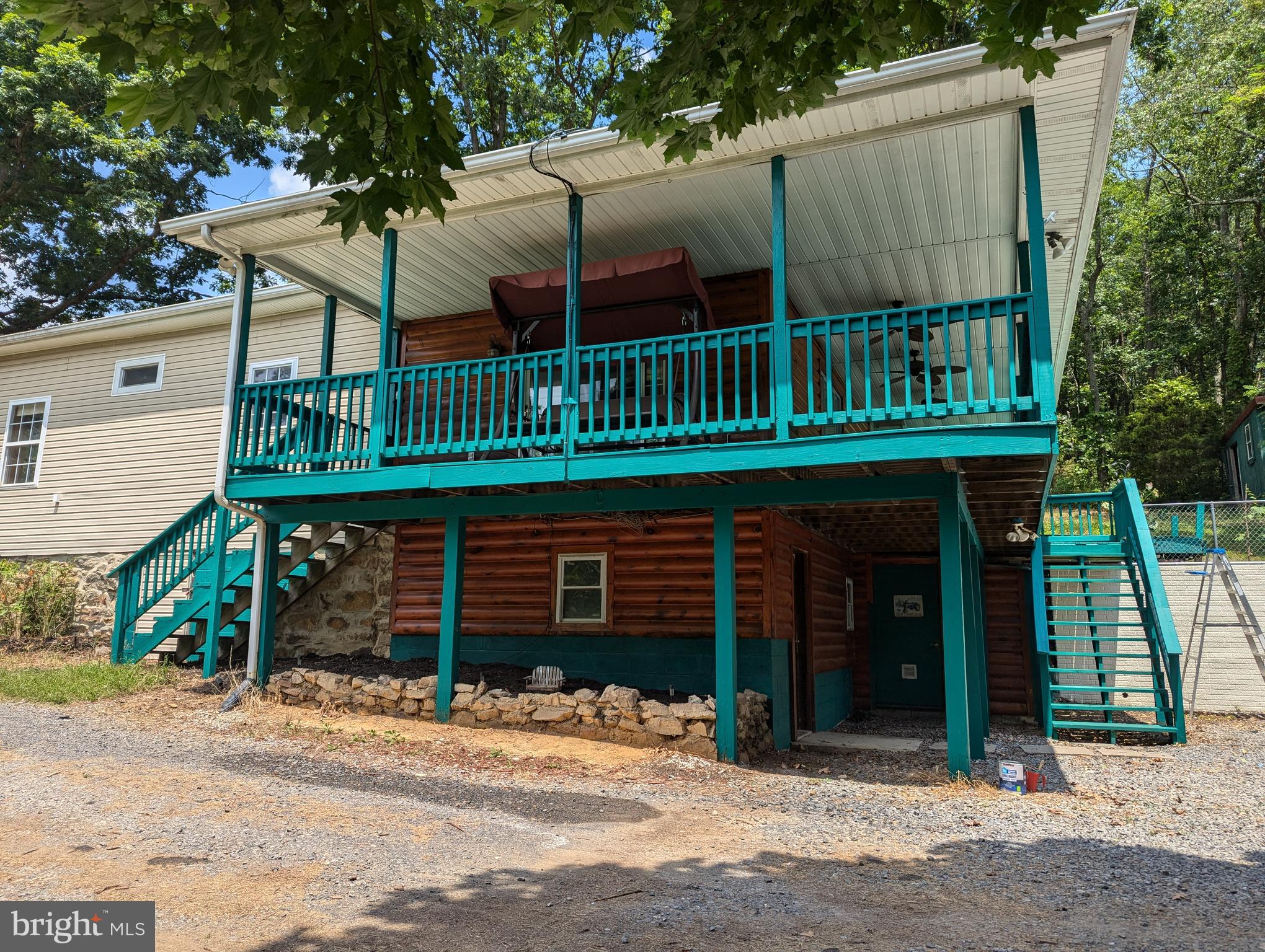 JUST REDUCED!! Lovely home sits on 6.07 acres of unrestricted land. This home has wrap around porch on 3 sides of the house with multiple ceiling fans for sitting out and enjoying the peace and quiet this house offers. Beautiful views all around the house and a firepit for enjoying the quiet nights. Multiple fruit trees including apple, peach, pear and plums.
The main house has 2 bedrooms and 1 bath with a spacious living room and dining room area. Kitchen has lots of cabinet space and an island between the living room and kitchen. Lots of windows and sliding glass door to allow all the natural sunlight in. On top of the 1000+ sq ft the main house has to offer there is an additional 300+sq foot separate entrance basement. Perfect for running a business or could be another living area, has baseboard heat installed and because it is in the basement it stays nice and cool during the summer without need for air conditioning.
Outside of the house is a 1 car garage and above that is another 300+ sq foot separate entrance “in law suite” potential living area. This is yet another huge open space that could be turned into an apartment or a huge office space, gym or whatever you can imagine.
There is an 8-foot greenhouse with a fan for growing your plants. Out back of the house there is a shed for storing tools and garden supplies that does have electric ran to it. Dedicated RV hookup was added last year and there is a ton of room for parking and an RV. The septic was upgraded to be above ground for easy RV dumping and removal.
Central location to Winchester, Cumberland, Keyser, Moorefield only being 30-40 minutes away. Martinsburg and Hagerstown are about 45-60 minutes away. NOVA and DC are only 1.5-2 hours away.
If you enjoy peace and quiet, want to soak up nature and have lots of potential to expand this is your chance.