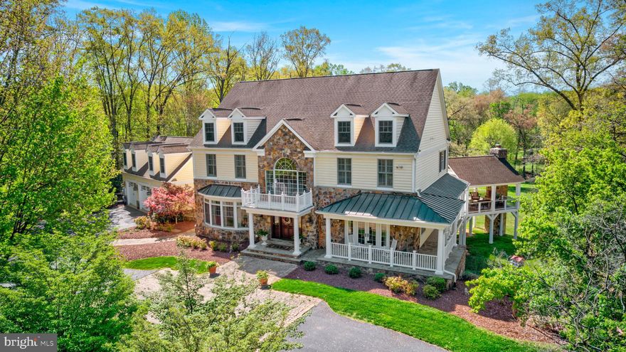 Bring on your horses!  Just 10 minutes from Reston Towne Center and 20 minutes from Tysons... yet you will feel like you're a world away on this idyllic 5-Acre Estate.  This one-of-a-kind property is nestled in the exclusive equestrian community of Vale Valley Farms, off Fox Mill Road.   With a wrap-around porch, an outdoor room with soaring stone fireplace and a deck spanning the entire length of the house, you'll enjoy a seamless blend of indoor and outdoor living.  A circular driveway leads you to the welcoming portico of this sprawling transitional home presenting about 8500 square feet of luxury living, with 7 Bedrooms, 8 Full Baths (including 2 Primary Baths), and 2 Half Baths.  From the formal Living and Dining Rooms to the Great Room with fireplace framed by arched bookshelves, the entire main level whispers quality and is flooded with natural light, wide open to the breathtaking acreage in which the home is artfully nestled.  The Living Rm actually could easily be repurposed as a Main Floor Bedroom, for multigenerational living.  Built-in speakers (throughout the house) allow you to listen to your favorite playlist for any occasion.  The Great Room flows seamlessly into the amazing gourmet Kitchen, outfitted with floor-to-ceiling white cabinetry, high-end stainless steel appliances including a Dacor 6 burner range with hood and pot filler, 2 refrigerators with freezers, a warming drawer, Meile built-in coffee maker and two large kitchen islands (one with seating for 6).  Counters are adorned with Quartz and an elegant marble tile backsplash.  An enormous Breakfast Room opens to the Deck and enjoys unobstructed views of the acreage.  A walk-in Pantry has an organizing system with a place for everything, while the Butler's Pantry is outfitted with white, lighted display cabinetry and a wine refrigerator.  Style to the max!  A mudroom offers a second half bath and access to the front yard, deck and 3 car Garage.  The upper level offers 5 Bedrooms and 6 Baths (one bedroom and bath in an au pair wing). The sumptuous Owner's Retreat is absolutely extraordinary and features a generous Bedroom with deep tray ceiling, and a Juliet balcony with amazing views. Sit outside on a summer's evening and enjoy a night cap before bed.  It also boasts a rare amenity-- two distinct Primary Baths, one with a jetted tub and both with well-appointed walk-in showers (one is a steam shower). They are thoughtfully positioned at opposite ends of the suite, each with walk-in closets with organizers, and a third closet just for shoes. Three spacious ancillary bedrooms each have private ensuite baths and walk-in closets. A separate Au Pair or In-Law Suite offers its own private living quarters (over 1,000 sf!) to include its own full bath.  Yet another opportunity for multigenerational living!  Alternatively, it presents an ideal opportunity for a home office, separate from the bustle of family living.  The full daylight walk-out Lower Level is a home unto itself!  It offers a Family Room with Fireplace and Wet Bar, a Game Room, a Den ... and 2 large Bedrooms and 2 Full Baths. One of the Bedroom suites has its own private egress. Also highlighting this level is an impressive Wet Bar with plenty of seating. The rich wood floor-to-ceiling built-ins make entertaining a breeze. NEW CARPETING insalled on 8/4/25,  4 zones HVAC, 3 of them replaced in 2024 and 2021.  Kitchen remodel 2023.  Rear porch addition 2016.  Outdoors, you’ll find 5 rolling acres, suitable for horses or a pool and resort-style living, with lush landscaping, matures trees, open space, with a creek running along the back of the property. Make it your own!  There are plenty of spaces to entertain…a charming wrap-around Porch, and Outdoor Room with stone fireplace and TV and an expansive deck with outdoor grill and bar. Gather with friends on a summer's evening and toast the good life, as the sun sets over your private 5-acre refuge, here in close-in Oak Hill.  Oakton HS pyramid.