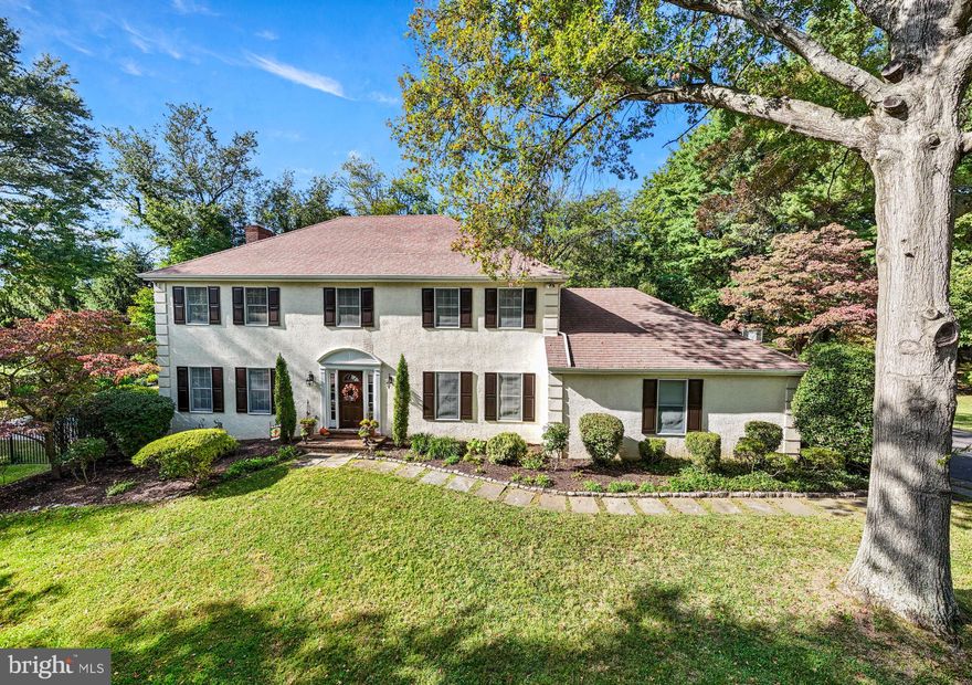 Welcome to this beautiful French Colonial home offering 4 bedrooms and 3.5 baths with over 3,600 square feet of living space situated on 1.26 acres. Tucked away on a quiet cul-de-sac in a highly sought after Bryn Mawr neighborhood, you'll be part of the top-ranked Radnor School District. This home is sure to catch your eye with its stunning curb appeal, highlighted by professionally landscaped grounds featuring trees, manicured gardens, and a sparkling in-ground pool. As you approach, a charming flagstone walkway with Belgium block border leads you to the entrance and into the welcoming foyer. Inside is filled with natural light and features a modern, neutral color palette throughout. The home is designed for easy everyday living and great for entertaining, with a layout that smoothly connects indoor and outdoor areas. On either side of the center Foyer, you'll find the elegant Living Room and formal Dining Room both with hardwood flooring, crown molding, and picturesque views of front yard. These spaces are complemented by a powder room and coat closet. At the heart of the home, the Kitchen and Family Room embrace an open-concept design, featuring ceramic tile flooring and showcasing beautiful views of the private backyard. A chef’s delight, the renovated kitchen features stainless steel appliances, granite countertops, a tile backsplash, and custom wood cabinetry with glass front accents, offering plentiful storage. A 7+ foot center island with seating for 4, a double-door pantry, and recessed lighting enhance the space, while an adjacent Mudroom area within the oversized 2-car garage adds practicality. The Breakfast area flows into the Family Room, with wood-beamed ceiling and a rustic, floor-to-ceiling stone fireplace with custom-built-ins and French doors. Step out onto the spacious, maintenance-free Trex deck with custom awning, which overlooks the serene rear yard and pool. Your private backyard retreat includes a large, rectangular pool with a royal blue mosaic border, diving board, spa, bonus regulation lap lane, all surrounded by elegant black wrought iron fencing.  Accented with beautiful hard scaping garden walls with perennial plantings, the paver patio is the perfect spot for grilling & dining by the pool plus grassy areas to play. In addition to the expanded driveway space for playing basketball and riding bikes, there are multiple yard spaces for playing sports and adding a firepit, gazebo, or swing set. Upstairs, the primary suite features a spacious bedroom, an impressive walk-in closet with built-in shelving and drawers illuminated by natural light, a second walk-in closet (with access to a large floored attic for storage or possibly converted to additional living space), a double door closet, custom wood blinds, and ceiling fan. Spa-like en-suite bath offers dual-sink vanity, jetted tub, vaulted ceiling with skylight, tiled floors, a tiled oversized shower with glass doors, and water closet. 3 sunny bedrooms, each with plush carpeting, ceiling fans, generous closet space, and custom wood blinds, share a full Hall Bath. One bedroom has direct bath access, making it perfect for guests or as a "princess suite." Updated Hall Bath includes tiled floors, a tiled tub & shower, a linen closet, window, recessed lighting, and a conveniently located laundry closet. Finished Lower Level provides almost 1,100 sq ft of versatile living space with Full Bath plus built-in countertop – ideal for a Home Office, homework zone, or arts & crafts space. Additionally, there is ample room for rec/game/movie room, exercise/playroom, or au-pair suite complete with custom closets and storage.  Located near major commuter routes, train station, private schools, and the vibrant Bryn Mawr shops & restaurants. , this home and property offer the best of Main Line living. Don’t miss the opportunity to make this home yours. Schedule your visit today!