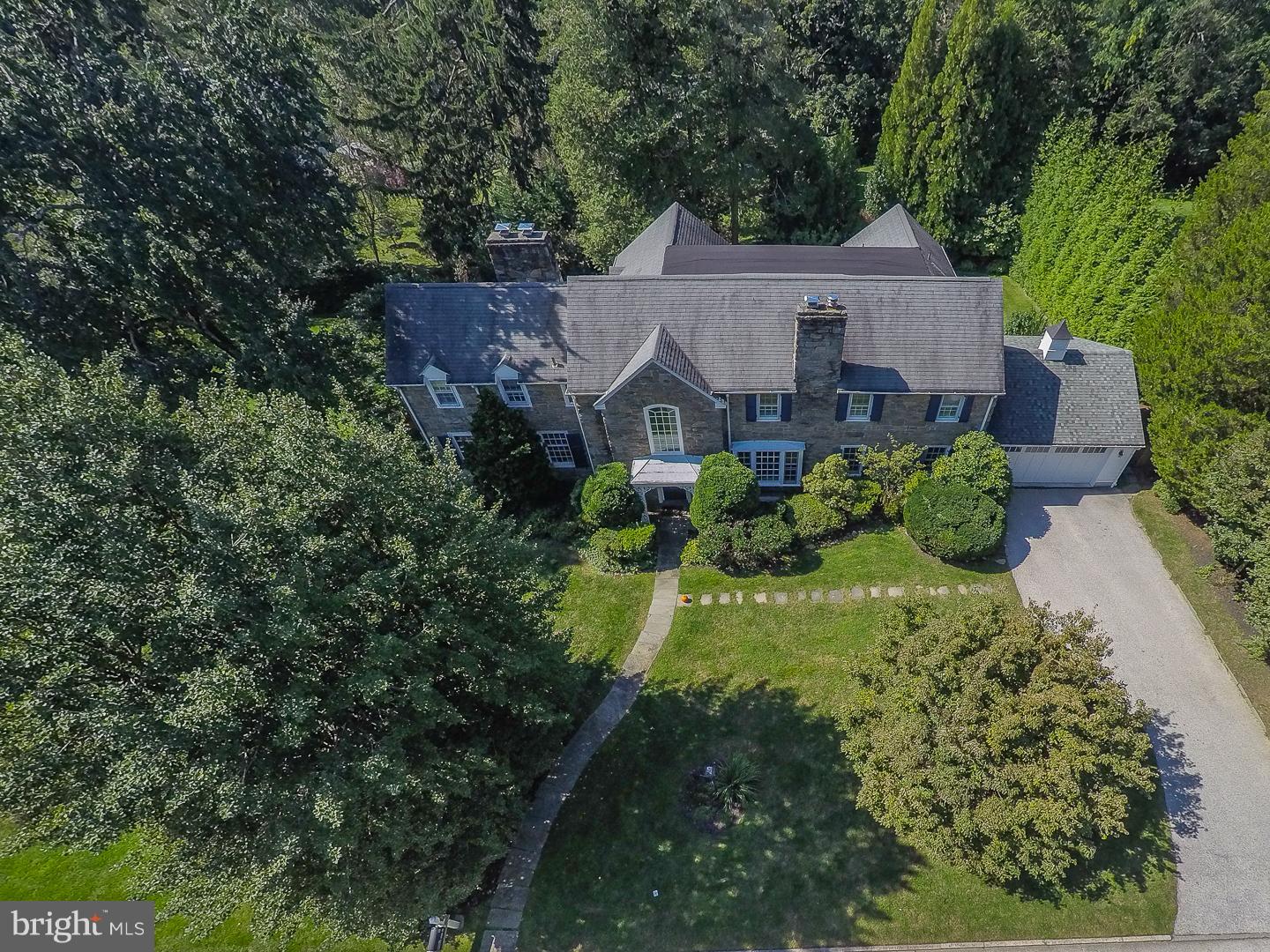 This classic stone colonial home has been extensively updated and expanded to include all of the desired living spaces without the excess. Located on the corner of Quiet Street and Quieter Road in one of Lower Merion's most desirable neighborhoods. Main level living areas include the large family room with built-in desk areas, shelves and cabinets. The eat-in kitchen is adjacent to the family room and includes a breakfast room, island with professional style gas cooktop, sub zero side by side, dual ovens, skylights and wonderful views of the back yard. Step down to the living room with a ceiling over 10 feet, bay window, and a marble fireplace. The office/den is accessed through the living room and features built-in cabinets and stone detail. The dining room looks over the rear of the property and includes a bay window, and crown and chair rail trim. All four of the bedrooms, the three full baths and the laundry room are located on the second floor. The master suite includes a brick fireplace, dressing-room sized walk-in closet, and en suite bath. Bedroom #2 also has an attached bath and features windows on three walls. The third full bath is accessed from bedroom #3 or the hallway. Bedroom #4 is located at a rear corner of the home and features a vaulted ceiling. In the finished walk-out lower level you will find the game room, a full wet bar, stone fire place, vented glass block window units, and twin lighted doors leading to one of two rear patios. Finished-in-place hardwood floors are present in most of the main and upper levels. The home last sold 21 years ago. Floor Plan, Seller Property Disclosure, Radon and Lead Paint reports are all available as attachments.