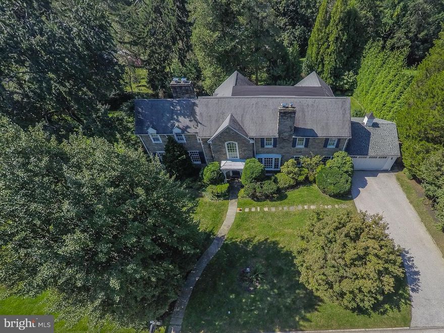 This classic stone colonial home has been extensively updated and expanded to include all of the desired living spaces without the excess. Located on the corner of Quiet Street and Quieter Road in one of Lower Merion's most desirable neighborhoods.   Main level living areas include the large family room with built-in desk areas, shelves and cabinets.  The eat-in kitchen is adjacent to the family room and includes a breakfast room, island with professional style gas cooktop, sub zero side by side, dual ovens, skylights and wonderful views of the back yard.  Step down to the living room with a ceiling over 10 feet, bay window, and a marble fireplace.  The office/den is accessed through the living room and features built-in cabinets and stone detail. The dining room looks over the rear of the property and includes a bay window, and crown and chair rail trim.   All four of the bedrooms, the three full baths and the laundry room are located on the second floor.  The master suite includes a brick fireplace, dressing-room sized walk-in closet, and en suite bath. Bedroom #2 also has an attached bath and features windows on three walls. The third full bath is accessed from bedroom #3 or the hallway. Bedroom #4 is located at a rear corner of the home and features a vaulted ceiling.   In the finished walk-out lower level you will find the game room, a full wet bar, stone fire place, vented glass block window units, and twin lighted doors leading to one of two rear patios.  Finished-in-place hardwood floors are present in most of the main and upper levels.   The home last sold 21 years ago.   Floor Plan, Seller Property Disclosure, Radon and Lead Paint reports are all available as attachments.