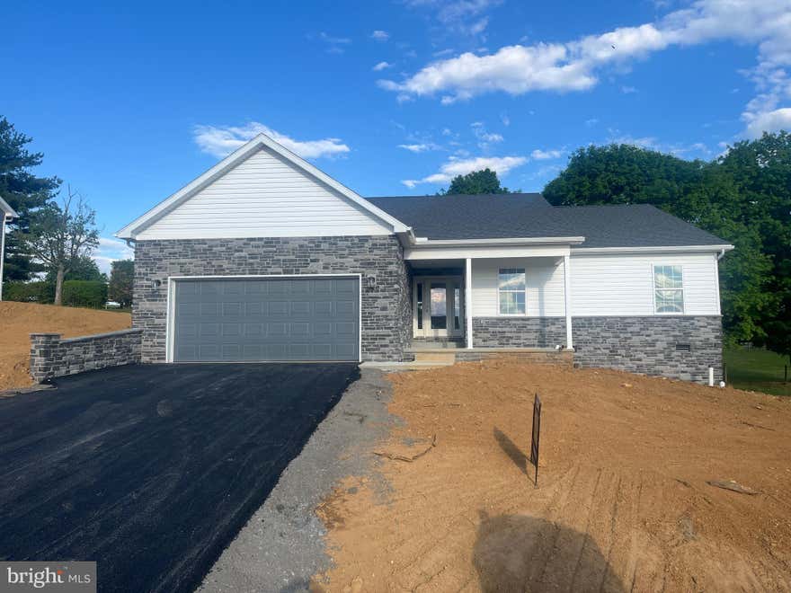 Discover a beautifully designed ranch-style home in the serene Antietam Commons, where modern craftsmanship meets timeless comfort. This new construction, set to be completed in 2026, estimated completion is 5/30/26. It showcases an inviting open floor plan that seamlessly connects the kitchen, dining, and living areas, perfect for both relaxation and entertaining. Step inside to find three spacious bedrooms, including a convenient master suite with a stylish tile shower. The heart of the home is the gourmet kitchen, complete with an island and a pantry, ideal for culinary enthusiasts. Luxury vinyl plank flooring flows throughout, enhancing the warmth and elegance of the space. The exterior boasts durable masonry and stone accents, complemented by a covered concrete front porch. Enjoy outdoor living on the charming patio, perfect for morning coffee or evening gatherings. The attached front-entry 24x24 garage provides easy access and ample storage. With a generous lot size of 0.23 acres, this home offers plenty of room for outdoor activities. The unfinished basement, with outside entrances, presents endless space for storage. This property is a true testament to thoughtful design and quality craftsmanship, waiting for you to make it your own. Embrace the opportunity to create lasting memories in a space that feels like home. *Interior Photos will be updated as home is completed* 4/29- Home is painted, and floors are installed.