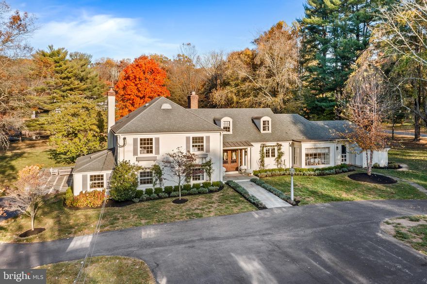 ***All offers are due by Thursday November 7th with a response date of November 8th by noon***Nestled on a dreamy, two-acre corner lot on one of the most scenic streets in Wayne, this sprawling, beautifully appointed 4/5 bedroom French country house brings countless conveniences and amenities to one breathtaking setting. From the large circular driveway, a new flagstone walkway leads to the covered front porch with distinguished glass-paneled entry door. Inside, the updated, freshly painted main level boasts refinished hardwood floors, designer lighting, custom millwork and access to the majestic backyard and its endless vistas from every room! Just off the updated foyer, an arched opening frames a sparkling white eat-in kitchen with inset cabinetry, quartz countertops, center island, double wall oven and farmhouse sink. The breakfast area beyond features a built-in desk and floor-to-ceiling windows with views of the lushly landscaped front yard. A French door conceals an expansive, brick-tiled mudroom with powder room, cubby storage, three closets (one walk-in!), laundry room with new washer and dryer, a secondary refrigerator and exterior doors leading to the front and rear yards. This side of the main level also boasts a light-filled dining room with window wall and direct access to the rear terrace, plus a spacious living room with wood-burning fireplace, recessed lighting and tasteful millwork. More space awaits off the other side of the foyer, where four steps lead to a repainted lower level with new flooring, renovated powder room and expansive family room with built-in window seat, wet bar, wood-burning fireplace and French door access to the side terrace. Opposite the family room there’s an optional fifth bedroom that could easily function as a home office, plus a bright and airy recreation room perfect for a home gym or play space. A refinished landing anchors the upper level, which houses two secondary bedrooms, a full hallway bath and a primary bedroom with a walk-in closet and ensuite full bath with radiant floor heating . A short flight of stairs takes you to the fourth bedroom with ensuite full bath, charming dormer windows and convenient attic access. The interior of this pristine home is only rivaled by its spectacular exterior. A new flagstone terrace wraps gracefully around the back and side of the home, offering ample space to soak in the sumptuous, secluded flat greenspace bordered by mature trees and a meandering creek. Other exterior highlights include a detached two-car garage, new stone entry pillars with custom lampposts and upgraded landscaping, including window boxes and trellises with climbing roses. Mill Dam Swim & Tennis Club is a short stroll (or golf cart ride!) away, along with the Radnor Trail, downtown Wayne, local parks and playgrounds. Make plans to tour this Main Line masterpiece—complete with money-saving, energy-efficient geothermal heat—today!