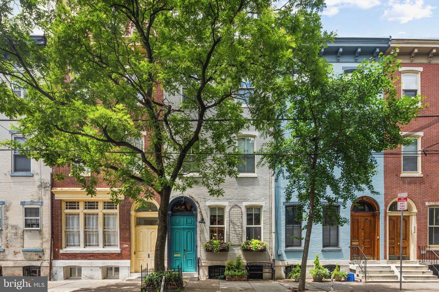 This spacious and bright 2020 RENOVATED 4 bedroom + den/study, 3 full and 1 half bath home is a few blocks from both Fitler Square and Rittenhouse Square. Recent alterations include OPEN first floor with new deluxe kitchen, fantastic storage, back deck and new primary bath. The East-facing living room has double historic doors, high ceilings, gas fireplace, reclaimed wood desk and many built-ins. Open dining area and kitchen with induction cooktop, two ovens, tile backsplash, farmhouse sink and custom reclaimed wood island with breakfast bar. Powder room, pantry and glass doors to back deck also on the level. Second floor rear family room/den/study with bay windows, crown molding and wood burning fireplace opens to storage area and full bath with glass enclosed shower, linen closet and extra-large washer and dryer. Spacious front bedroom with high ceiling and bottle glass door transoms. Third floor rear features two bedrooms and tiles hall bath with glass enclosed shower. Front primary bedroom with dramatic two-story-high ceiling with loft, ensuite bath with pocket door, soaking tub, double sink vanity and glass shower enclosure. Fourth floor loft overlooks primary bedroom and is perfect for a home office or gym. Roof deck with skyline views. High ceilings, copious storage, Schoolhouse light fixtures and restored original wood floors throughout. This home has the perfect mix of radiator heat and 5-zoned new (2020) AC system controlled by 3 air handlers and thermostats. Bellweather handled the design/build which included excavating the basement to create a higher ceiling and new concrete floor. This lower level provides storage and a hobby/art studio with utility sink. Basement is also plumbed for a bathroom if the next owner chooses to add one. Great location with a 98 Walk Score rating in the Greenfield School catchment, easy walk to universities, hospitals, Comcast Center, playgrounds, grocery stores, Schuylkill River Trail, museums, restaurants and  shops.