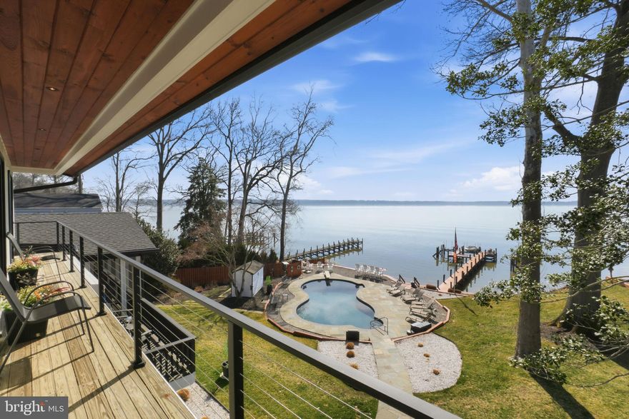 Exceptional Potomac River Retreat in Hallowing Point River Estates—one of Fairfax County’s most coveted waterfront enclaves—this remarkable residence enjoys a prime position along the broad, scenic waters of the Potomac River at the edge of the Mason Neck Peninsula. Impeccably maintained and completely transformed, the home offers a refined, resort-style living experience surrounded by tranquil water views and lush natural beauty.

Panoramic river vistas are showcased from every level, and the property has undergone a whole-house interior and exterior renovation, with no surface left untouched. The gourmet kitchen is a true showpiece, offering breathtaking river views, elegant Shaker-style cabinetry, quartz countertops throughout, and a curated collection of premium stainless-steel appliances, highlighted by an impressive extra-wide refrigerator/freezer. Anchoring the space is an expansive island with breakfast bar, perfectly suited for both elevated entertaining and everyday living. The sun-drenched family room boasts fresh, modern black sliding glass doors that open effortlessly to a composite screened porch with a vaulted wood ceiling, positioned on an expansive deck overlooking manicured grounds and the river beyond. There is an additional screened porch in the lower level that makes outdoor living a breeze. A Generac whole-house standby generator ensures uninterrupted comfort and peace of mind year-round.

The residence offers four spacious bedrooms and five beautifully appointed bathrooms. The primary suite is a private retreat, highlighted by an upper-level deck overlooking the Potomac River, creating the perfect setting for morning coffee or sunset views. Additional living spaces include an elegant bar and entertainment room, multiple outdoor gathering areas, and thoughtfully designed indoor-outdoor living that maximizes the home’s exceptional waterfront setting.

Approximately 125 feet of Potomac River frontage with riparian rights anchors this exceptional offering, complemented by a 135-foot private dock with two boat lifts. The waterfront infrastructure includes a vinyl seawall installed in 2008, seven ice-breaker pilings, and retaining walls added in 2020 by Delta Marine Construction. Enhancing the outdoor lifestyle is a resort-style saltwater in-ground pool with diving board, a brand-new T-Cell (required for salt water pools), and rough-ins for a propane pool heater and hot tub, allowing flexibility for future enhancements. Slate terraces and a pool storage outbuilding complete the exterior amenities.

This property is a Nature Lover’s Paradise! The grounds feature a beautiful mix of fruit trees and native Virginia plantings, creating a serene, living landscape. With regular eagle sightings and abundant birdlife, it’s a dream for birdwatchers. Relaxing on the expansive upper deck with your morning coffee or sipping your favorite beverage while floating in the pool—this property truly celebrates outdoor living.

Nestled in a renowned haven for outdoor enthusiasts, this area is a dream for nature lovers and boating fans alike, offering a community dock for visiting guests along with multiple nearby marinas. Residents of Hallowing Point River Estates enjoy access to an impressive suite of community amenities, including a private beach, tennis and pickleball courts, basketball court, playground, volleyball area, pavilion, and a community dock with boat and kayak launch. The community is surrounded by thousands of acres of protected federal, state, and regional parkland and is conveniently located just 27 miles south of Washington, DC, near Old Town Alexandria and only six miles from Fort Belvoir. Commuters will appreciate the nearby VRE station and quick access to I-395, while outdoor recreation abounds with local bike and hiking trails, Pohick Bay Golf Course, camping, and equestrian stables all just minutes away!