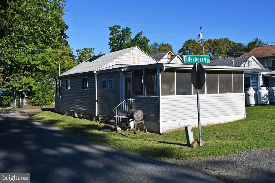 Affordable beach cottage in Crystal Beach Manor.  If you are willing to put the work in, you will have a very cozy property at the beach for making memories.  There is a heat pump for central heat and air.  The property is on a holding tank which the current owners have pumped once a year.  Limited water views from the property will increase as the leaves fall.  Screened porches front and rear for enjoying the summer breezes.