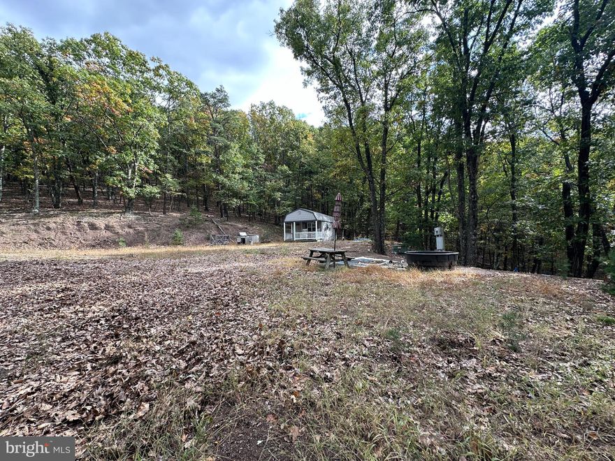 READY TO ROLL.....NEARLY 10 PRIVATE WOODED ACRES WITH ALL UTILITIES IN PLACE; PUBLIC WATER, 3 BEDROOM SEPTIC AND ELECTRIC! CUTE SHED, 2 RV HOOK UPS AND CLEARED BUILD/CAMP SITE.....50K WORTH OF INFRASTRUCTURE DONE! ALL YOU NEED IS YOUR BLUEPRINTS AND A CHAINSAW TO OPEN UP THE BREATHTAKING NORTHWEST VIEWS OF THE TOWN OF ROMNEY AND SOUTH BRANCH RIVER VALLEY.  INCREDIBLY PRIVATE, YET SURPRISINGLY CONVENIENT.....LESS THAN 1/2 MILE OFF THE PAVED ROAD AND ONLY 5 MILES TO EVERYTHING THE ROMNEY AREA HAS TO OFFER....SCHOOLS, HOSPITAL, SHOPPING, RESTAURANTS & RIVER. LOCATED IN PRIVATE GATED COMMUNITY OF CARDINAL RIDGE, CIRCA 2006. STAY CONNECTED WITH GREAT CELL SERVICE AND FIBER INTERNET BEING INSTALLED IN THE COMMUNITY RIGHT NOW! HUNT, CAMP, SHOOT, RELAX....BUILD YOUR WEEKEND OR FOREVER HOME HERE. YOU DON'T NEED A PICK AX TO UNEARTH THIS HIDDEN GEM.....JUST MAKE THE CALL, MAKE THE DRIVE, WRITE THE CHECK AND START ENJOYING ALMOST HEAVEN!