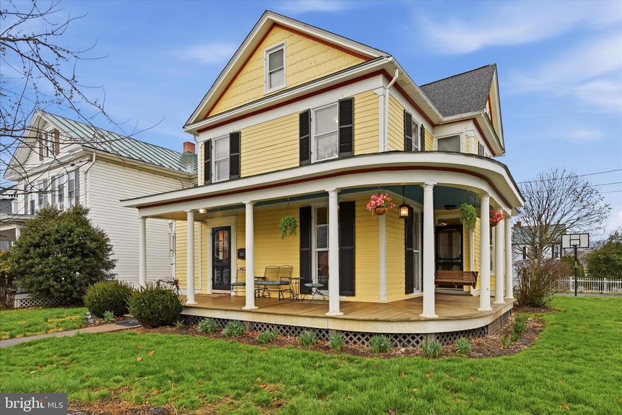 Welcome to 220 S. Massanutten Street in downtown Strasburg! This Queen Anne influenced Victorian home noticeably retains the character of yesteryear, while featuring all the conveniences of modern living! Built originally in 1892, this charming property has been lovingly rebuilt over the past twenty years.  From plumbing to central air, no stone has been left unturned to ensure this beauty thrives for another 135 years.  Hardwood floors can be found throughout this five bedroom, three bathroom home.  The main floor showcases a custom brick fireplace flanked by built in shelving. The dual staircase is a must for every lover of historic homes. The kitchen has been tastefully updated with granite countertops, stainless steel appliances, tile backsplash & island. Large laundry and mudroom area are conveniently located between the kitchen and covered back porch. On the second floor sits a primary suite with attached bathroom and walk in closet - a treat in a home of this age and character!  The attic has been finished as a fifth bedroom or flex space, complete with a built in stage and thoughtful storage. The carriage house has been restored and converted into a workshop and garage. Be sure to notice the fully fenced yard behind the garage! Fun details that have been preserved include wood interior doors, much original hardware, grates from the days of the coal furnace and more. In the early 20th century, the home served as a finishing school for girls.  Sitting in view of Massanutten mountain, the home is also walking distance to Box Office Brewery, The Strasburg Emporium, shopping, dining and the Shenandoah River Walk. You must see this home in person to appreciate all it has to offer. Don't waste this opportunity to rock away the evening on the wrap around porch of your very own dollhouse!