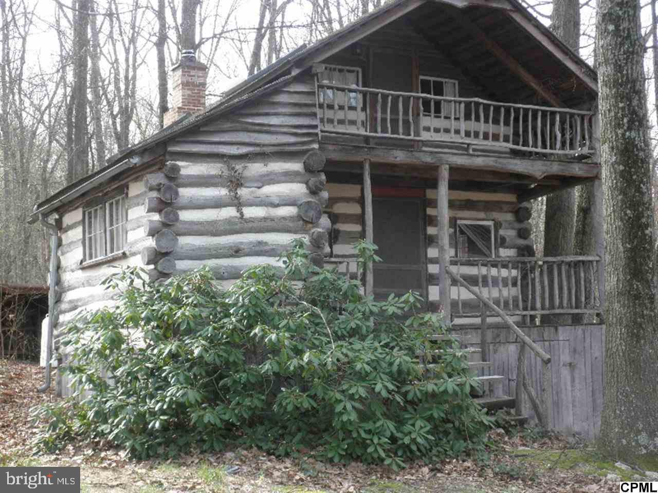 Forst cabin. This get a way property features a 2 story log cabin built in 1976. 2 bedrooms on 2nd floor. One full bath. Kitchen/Dining room. Central forced air / gas heat. Stone fireplace. 3 outbuildings. 14x30 barn/studio w/ wood and concrete flors, wood burning stove, electric and 14x15 loft. Garage/shed plus a large pottery kiln. All on this 9 acre wooded parce.