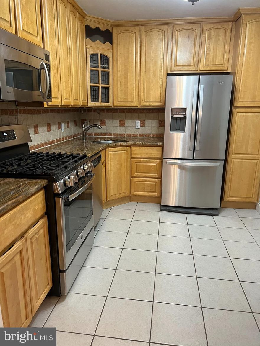 Stunning two bedroom two bathroom condo centrally located in The Kenwood Condominium Building with soaring tree-lined city views. Featuring gleaming hardwood floors and beautiful moldings, the sun-filled combination living / dining room enjoys a private balcony with beautiful sunsets and is connected to the kitchen, creating wonderful entertaining flow in the home. The kitchen offers stainless steel appliances and a gas stove. The bedrooms feature parquet floors, crown and baseboard moldings, beautiful views, and renovated full bathrooms. Additional offerings include garage parking, dedicated storage, and all utilities included. The Kenwood has 24-hour security/concierge in a recently renovated lobby, a secure mail room, a state-of-the-art fitness center, a large outdoor pool, an expansive meeting room with a full kitchen, a walking path around the professionally landscaped promenade with two picnic areas complete with gas grills and seating, and a laundry room on every floor.  Conveniently located just steps to the Capital Crescent Trail, Whole Foods, Georgetown Bagelry, the Giant, and Downtown Bethesda.  Westbrook ES, Westland MS and B-CC HS serve the neighborhood.