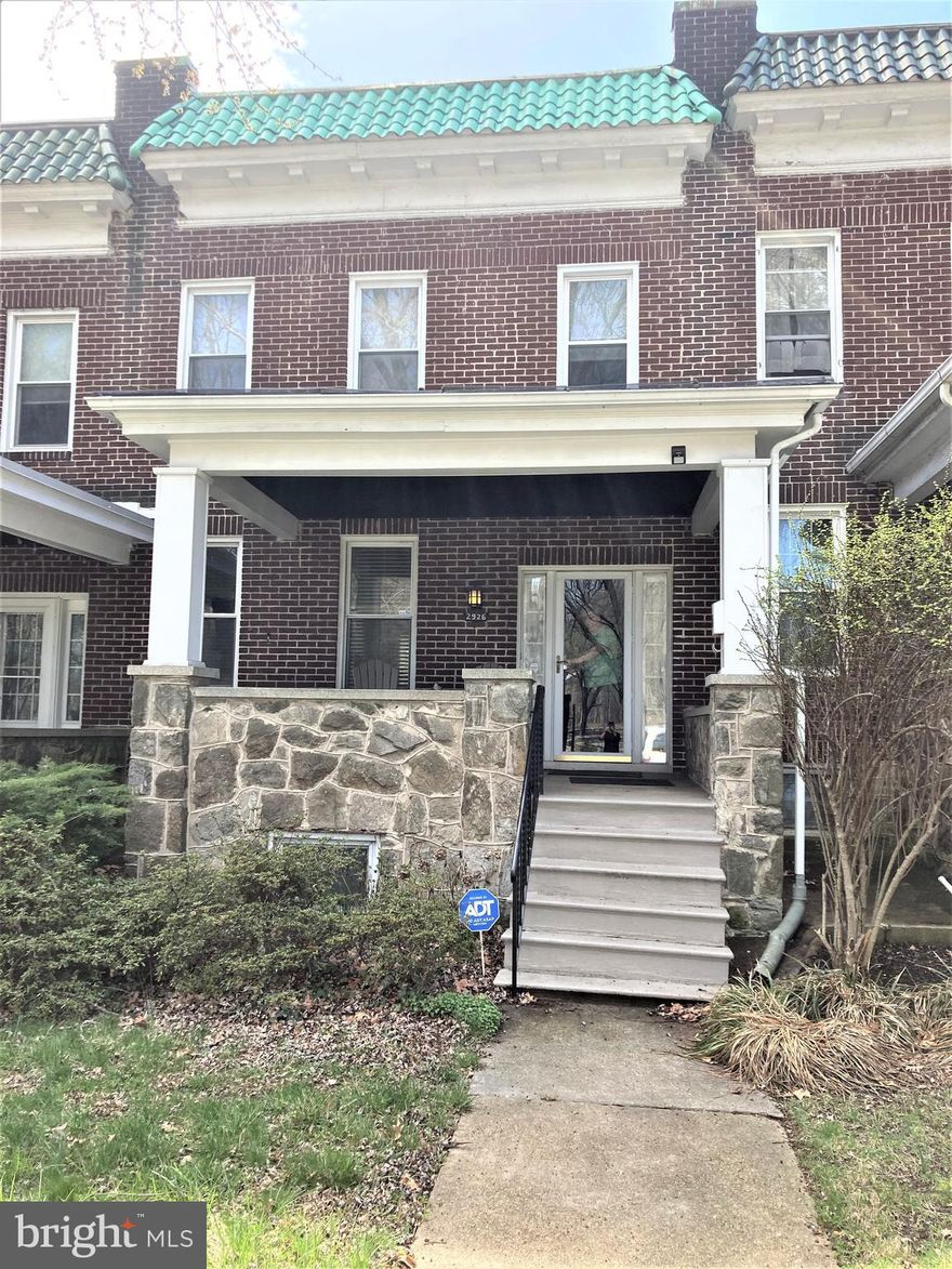 Spacious four-bedroom, two full bath home with front porch perfect for sitting on a summer evening overlooking the Baltimore Museum of Art and the Homewood campus of The Johns Hopkins University. Enter the welcoming foyer, open to the living room which passes into the generous dining room. The galley kitchen includes a large pantry and access to the back yard. On the second floor, there are four bedrooms that share a hall bathroom. The lower level has a finished family room, and a full bathroom.  There is also a large laundry/storage/utility room that has walk-out access to the back yard. A second storage room on the lower level is located under the front porch. The home features original hardwood floors with inlays throughout, decorative fireplace in the living room, vintage lighting and wall sconces, central air conditioning approximately three years old and a waterproofed lower level. Easy access to Interstate 83 is a convenient point for those who would like to enjoy city life while having the ability to commute into or away from the city with ease or a 50-minute train ride into Washington, DC from Baltimore Penn Station.  With the ability to walk to many shops and restaurants this home is excellent for those looking to adventure within walking distance of their home. Come and tour this wonderful circa 1924 home today.