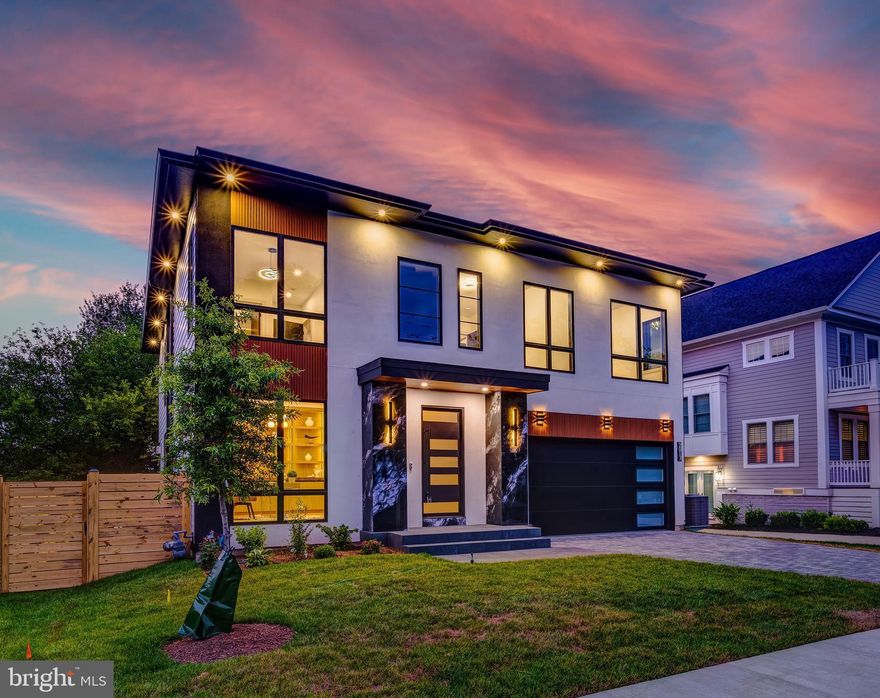 Introducing 2017 N. Greenbrier Street — a striking new construction contemporary residence offering nearly 5,000 square feet of thoughtfully curated living space. With 5 bedrooms, 4 full bathrooms, and 2 half bathrooms this home exemplifies modern elegance, elevated by luxurious finishes and timeless design.
The sleek stucco exterior, accented by bold marble pillars, makes an unforgettable first impression and sets the stage for the sophistication within. Step into a grand foyer featuring tray ceilings, elegant wainscoting, and wide-plank oakwood flooring that flows seamlessly throughout the home. Expansive Pella casement windows bathe the interior in natural light, highlighting the home's open and airy ambiance.
The gourmet kitchen is a chef’s dream—outfitted with top-of-the-line JennAir appliances including double wall ovens, a gas cooktop, built-in microwave, and coffee maker. Custom cabinetry is paired with sleek glass accent doors and a show-stopping marble island and backsplash. A modern light fixture defines the large dining area, which opens into a stunning family room featuring a dramatic floor-to-ceiling fireplace and architecturally designed square recessed tray ceiling insets. Designer lighting throughout adds an elevated touch. An elegant office with built-in cabinetry and a stylish half bath complete the main level.
Step outside to a tree-lined backyard oasis featuring a spacious back porch with sleek glass railings and a separate patio—perfect for both lively entertaining and serene relaxation.
Upstairs, four generously sized bedrooms and three full bathrooms offer comfort and privacy, with each bedroom enjoying direct bathroom access. The primary suite is a true retreat, complete with its own floor-to-ceiling fireplace, a spa-like ensuite with matte black porcelain tile, a freestanding soaking tub, walk-in shower with bench seating, and a full wet bar with wine racks and beverage fridge. The gigantic custom walk-in closet is designed to impress. A dedicated laundry room with a sink, folding station, and front-loading washer and dryer adds functional ease to the upper level.
The walk-out lower level expands the home’s livability with a large recreation room, a second full bar with marble countertops, a fifth bedroom, a fourth full bathroom, and a flexible bonus room—perfect for a home gym, studio, or additional office. A convenient half bath is also included on this level.
Additional highlights include Kohler bathroom fixtures, lit vanity mirrors, and high-end finishes throughout.
This exceptional home masterfully combines modern architecture, luxury detail, and practical design creating an extraordinary opportunity to own a truly one-of-a-kind property in the heart of North Arlington.