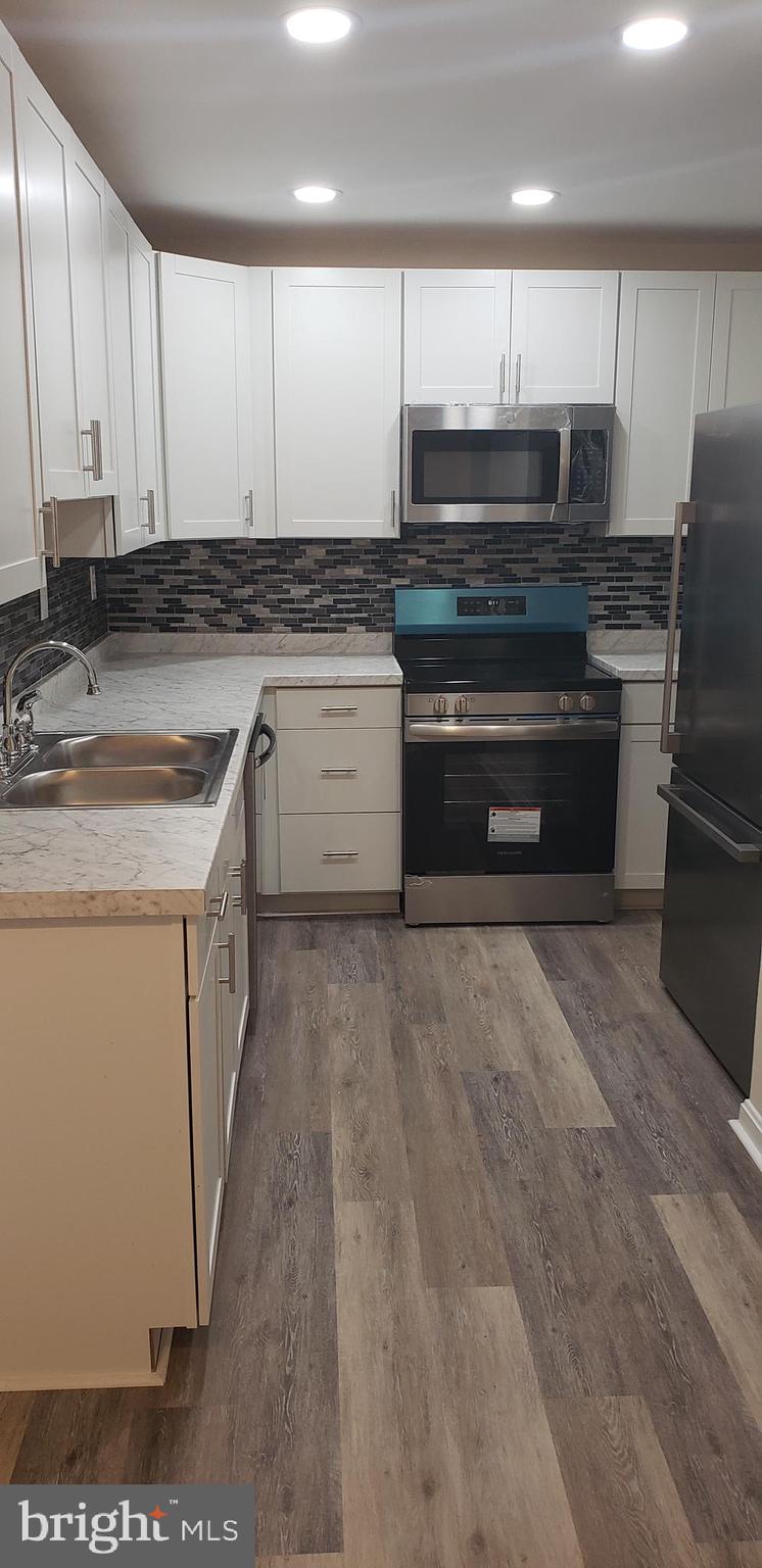 Great opportunity for 1st time buyer or investor. Just completed renovation with new paint and all new flooring make this home move in ready. Brand new kitchen cabinets and counters with upgraded appliances, tile backsplash and recessed lighting! Roof replaced last year. Uplevel full sized front loading washer and dryer included for your convenience. 2 reserved parking spaces right in front and visitor parking for guests nearby. Secured storage shed with light and brick patio in back in fully fenced yard. Don't miss this exceptional value to live close to I95 and all Central Park has to offer.