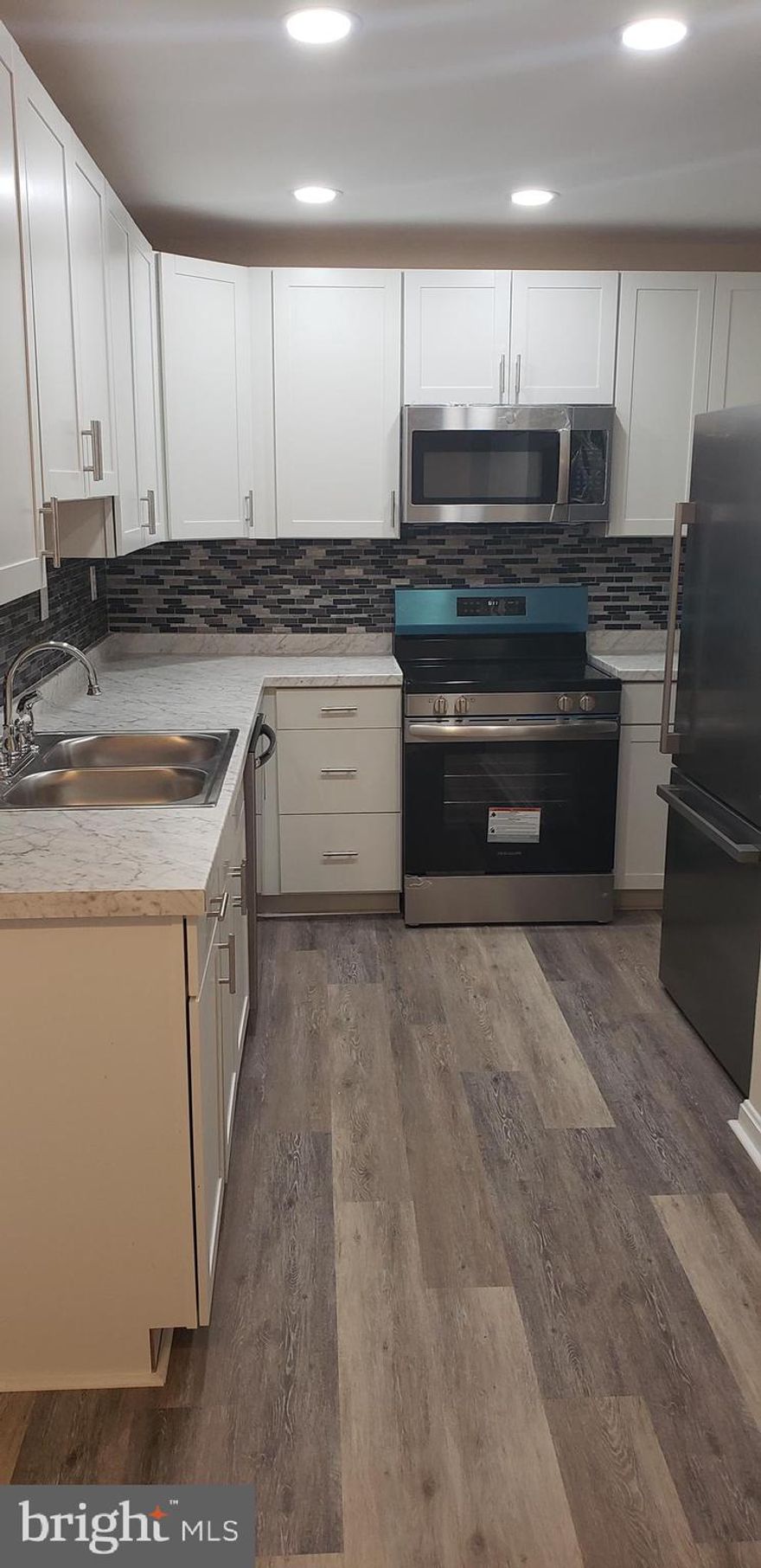 Great opportunity for 1st time buyer or investor. Just completed renovation with new paint and all new flooring make this home move in ready. Brand new kitchen cabinets and counters with upgraded appliances, tile backsplash and recessed lighting! Roof replaced last year.   Uplevel full sized front loading washer and dryer included for your convenience. 2 reserved parking spaces right in front and visitor parking for guests nearby. Secured storage shed with light and brick patio in back in fully fenced yard.  Don't miss this exceptional value to live close to I95 and all Central Park has to offer.