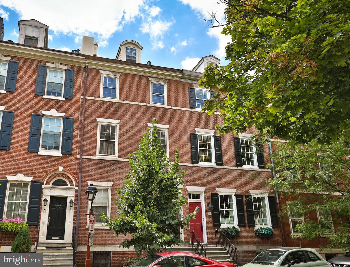 This enormous Federalist Society Hill townhome was built c.1810 and renovated, in 1972 with a distinctly mid-century Modern approach, by renowned Philadelphia artist Sam Maitin with the help of his brother Irving (AIA), an award-winning, Harvard- and Penn-educated architect. The Artist’s studio still occupies the first floor and features a massive open space with 10-foot-high ceilings; the three floors above were the family residence. A spacious eat-in kitchen at the rear of the second floor opens onto a large living area with fireplace and the front room which has a full en-suite bath and can serve as both family room and guest bed. The third floor has two well-proportioned bedrooms and shared bath, and the top floor has a primary bedroom suite with an anti-chamber/library/sitting room separated from the sleeping area by a 12-foot x 8-foot barn door. The house is looking for its next iteration from a buyer who wants to put their own imprimatur on this a distinctive and stately home on one of Society Hill’s finest blocks. The first floor can remain a professional space or be transformed into the family living area, making room for more beds on the upper floors. With the included additional lot (703 Addison) that extends all the way back to Addison Street in the rear, there is ample room for 2-car parking along with a very generous garden area. Please note the RM1 zoning which can allow for an owner's unit on the upper floors and an income unit to be built on the lower level.