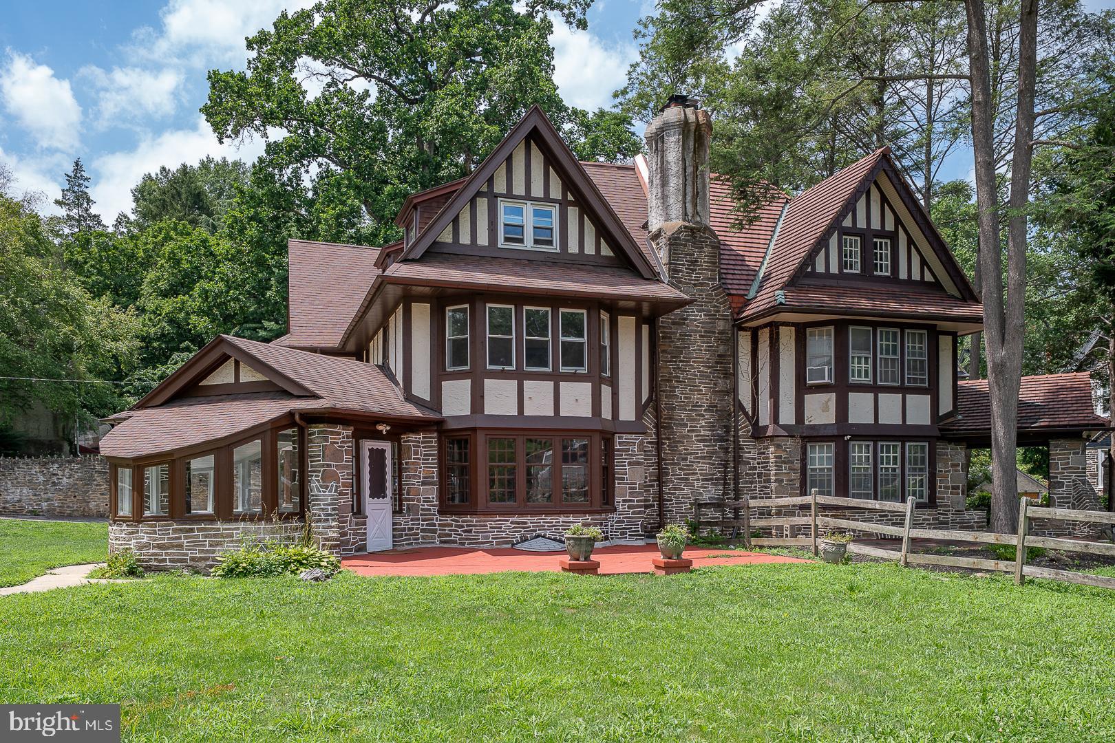 Welcome to 6640 Lincoln Drive — a stunning, updated home that blends timeless architectural elegance with contemporary comfort. With over 5,100 square feet of living space, this stately property features 6 bedrooms, 3 full bathrooms, and 3 half bathrooms, making it ideal for today’s lifestyle. Step into the unique curved sunroom, a warm and inviting entry that sets the tone for this special home. Inside, the formal living room boasts exposed wood beams, gleaming hardwood floors, and an ornate wood-burning fireplace, all of which echo the home's rich historic character. The living room flows seamlessly into the elegant dining area and the updated kitchen, complete with stainless steel appliances, breakfast bar, and ample cabinetry. Just off the kitchen, you’ll find a spacious laundry/mudroom and a convenient half bath. Upstairs, the expansive primary suite offers a serene retreat, featuring a wall of built-in bookshelves, a second wood-burning fireplace, a luxurious full bath, and a walk-in closet. Two additional bedrooms on this level share a charming Jack-and-Jill bathroom. The third floor features three spacious bedrooms and a full hall bath, providing ample space for family, guests, or home offices. The finished basement adds even more versatility with space for a gym, rec room, or media area, along with an additional half bath. Situated on a beautiful, tree-lined street on a corner lot in desirable West Mt. Airy, this home is the perfect combination of historic beauty and thoughtful updates. Located close to shopping, restaurants, Fairmount Park, and public transportation. Easy commute to Center City. A rare opportunity to own a true Philadelphia classic!