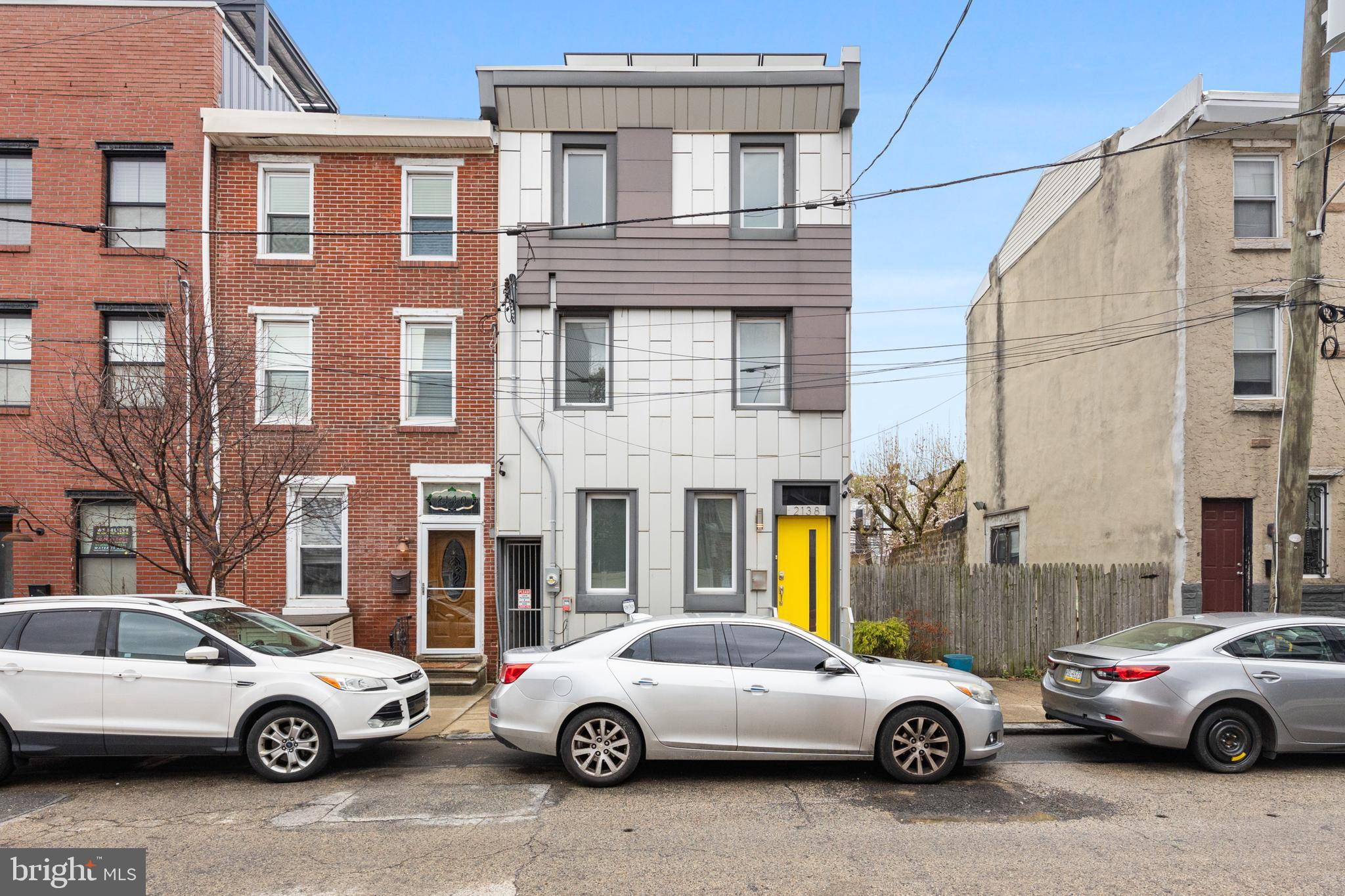Here's your chance to own a unique property that puts you in the middle of all Fishtown has to offer, including restaurants, coffee shops, boutiques, and bars! 2138 E Arizona St. welcomes you with high ceilings and hardwood floors. On the main floor, you'll find a comfortable living room, charming breakfast nook with a custom bench, and a convenient powder room. With its abundance of natural light, premium cut granite countertops, oversized island, and stainless steel appliances, the stylish kitchen is sure to impress. It leads to a spacious backyard with a fully paved surface. It is the perfect place to host family and friends. When not entertaining, there is parking for two cars as well as an EV charging port that is hardwired all secured by a rolling garage door. On the second level, there are two large rooms and a modern ceramic tiled bathroom. After a long day, the private primary suite on the 3rd floor offers a luxury en-suite bathroom with a fully tiled walk-in shower and a double sink vanity. From the primary bedroom, you can enjoy the view from the roof deck. Additional flex space is available in the partial basement. Additionally, you can enjoy the savings of solar panels without paying an additional monthly fee. Make sure you schedule a tour before it's too late!