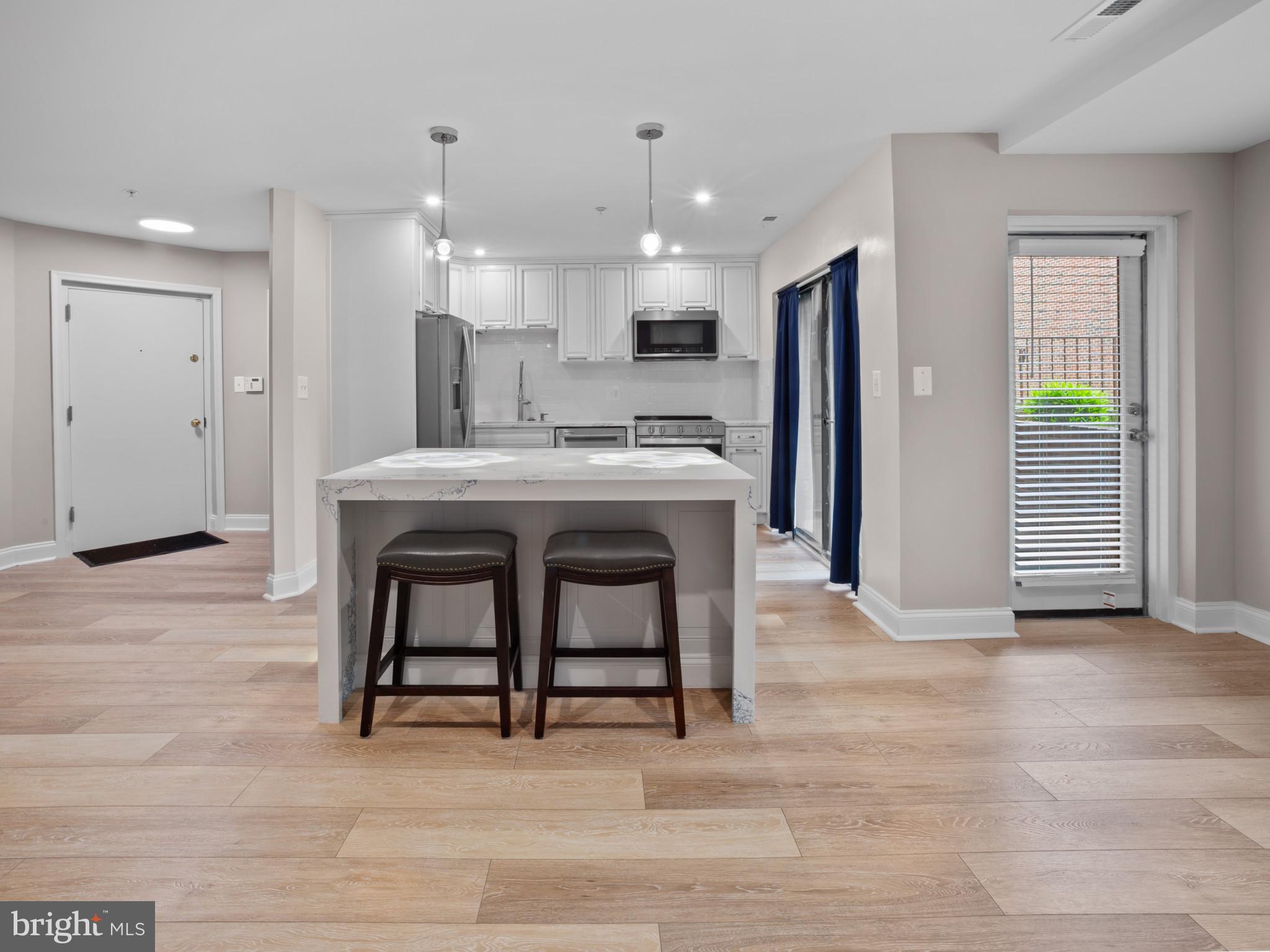 Welcome to this beautifully renovated 2-bedroom, 2-bath condo located in the sought-after Chapel Hill community of Perry Hall. Fully updated in 2024, this home offers a modern, open floor plan designed for both comfort and style. Step inside to discover gleaming hardwood floors, recessed lighting throughout, and an abundance of natural light that fills every corner. The stunning kitchen is a true centerpiece, featuring Quartz countertops, stainless steel appliances, an oversized island with generous counter space, and ample storage—perfect for everyday living and entertaining. The spacious primary bedroom includes a luxurious ensuite bathroom and a walk-in closet, offering a private retreat. The versatile second bedroom is ideal as a guest room, home office, or creative space. Enjoy your morning coffee or unwind in the evening on your private patio overlooking beautifully manicured garden views—your own peaceful oasis. Additional features include a dedicated parking space and plenty of guest parking. Ideally located just minutes from shopping, dining, and major commuter routes including I-95, I-695, and Route 1, this condo offers both convenience and tranquility. Don’t miss the opportunity to make this exceptional home yours!