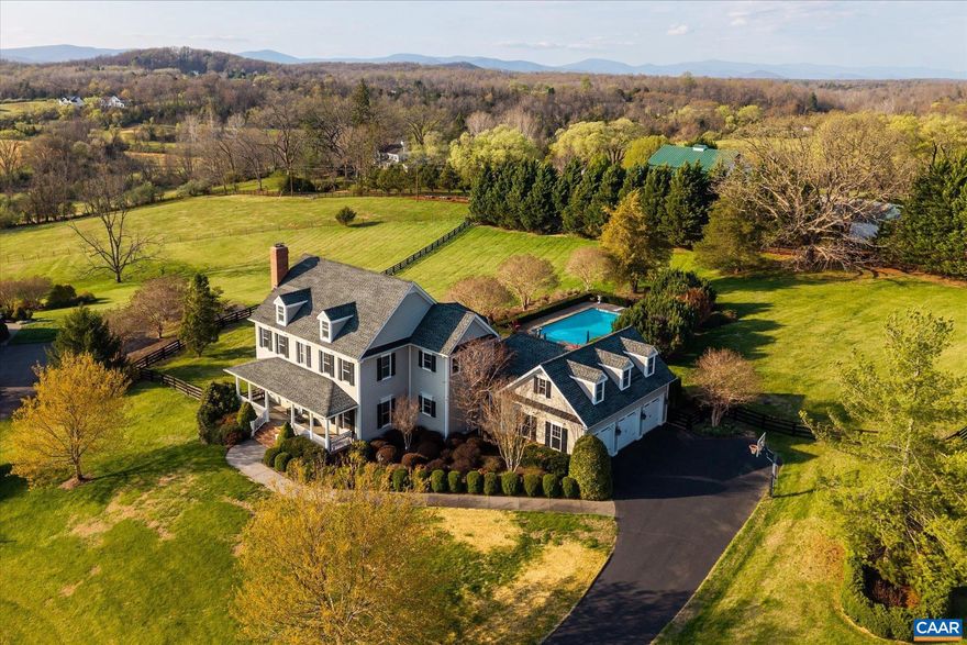 Elegant traditional-style residence (circa 2005) tucked away on a private cul-de-sac, on an elevated 2-acre parcel in Ivy?s premier The Rocks community. Offers sweeping, protected views of the Blue Ridge and Ragged Mountains. Thoughtfully designed to maximize its remarkable setting, the 5-bedroom, 5.5-bath home features nearly 5,000 finished square feet of refined, light-filled interiors with seamless indoor-outdoor flow to expansive porches, decking, terraces, and a gated in-ground pool. Generously proportioned rooms, a stunning, well-appointed kitchen, and inviting gathering spaces offer a balance of sophistication and livability, perfectly suited for both everyday living and entertaining. Four-board fencing, pastoral and mountain views, and a stately mature oak tree frame the estate setting, just minutes from the University of Virginia and Charlottesville?s amenities. A distinguished offering in one of Western Albemarle?s most desirable communities.,Cherry Cabinets,Granite Counter,Wood Cabinets,Fireplace in Basement,Fireplace in Family Room,Fireplace in Living Room