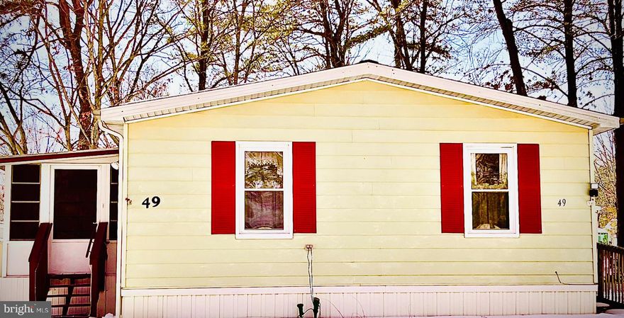 This delightful single-wide manufactured home, built in 1982, offers a move in ready, cozy retreat with three spacious bedrooms and two full bathrooms, perfect for comfortable living. Step inside to find a warm ambiance enhanced by a gas fireplace, ideal for cozy evenings. The kitchen is equipped with ENERGY STAR appliances, including a clothes washer, dryer, extra refrigerator/freezer, stove, and dishwasher, ensuring efficiency and convenience for your daily routines. Enjoy the outdoors from your enclosed porch, a perfect spot for morning coffee or evening relaxation. The community boasts a refreshing pool, inviting you to socialize and unwind with neighbors. With 49 pads, Shenandoah Village fosters a close-knit atmosphere where friendships flourish. The neighborhood is enriched with nearby parks, providing ample opportunities for leisurely strolls and outdoor activities. Local schools and public services are easily accessible, enhancing the convenience of daily life. Parking is a breeze with a concrete driveway accommodating two vehicles. Embrace the comfort and community spirit of Shenandoah Village, where every day feels like home. This is more than just a property; it's a lifestyle waiting for you to enjoy.  The roof is 1 year New.  Washer and dryer are new and will remain.  This is an as is sale ready for the new owners to move right in.