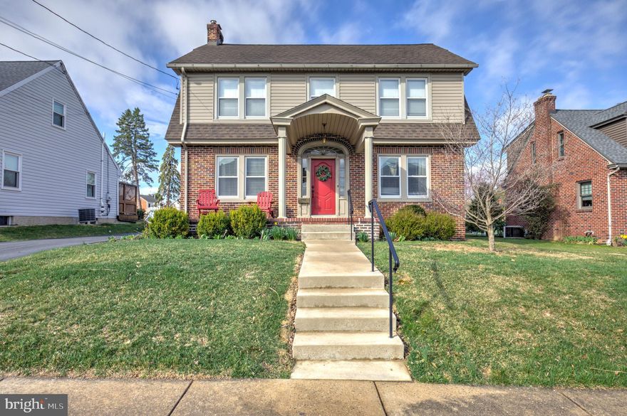 Beautiful Restored Dutch Colonial in New Holland Borough - A True Gem! The maintenance-free exterior showcases a mix of brick, slate, and vinyl, complemented by aluminum-clad trim and energy-efficient double-pane vinyl windows. Inside, you'll find hardwood floors, classic millwork with tall baseboards, and vintage glass doorknobs, enhancing the home's timeless appeal. The kitchen features custom cherry cabinetry that flows into a bright and inviting dining room. The screened porch leads to a 18' x 14' deck, ideal for relaxing or entertaining outdoors. The spacious living room is anchored by a beautiful brick fireplace, adding warmth and character to the space. The upper levels offer four cozy bedrooms, along with a stunningly remodeled full bath. Additionally, there is a second full bath conveniently located on the first floor. Outside, the matching brick 2-car garage enhances the home's curb appeal and sits on a level, well-maintained yard - perfect for gardening or outdoor activities. The garage has been thoughtfully transformed into the ultimate gathering space, offering plenty of room for entertainment. Whether you choose to enjoy this current setup or revert it back to a 2-car garage, the possibilities are endless! This home combines old-world charm with modern amenities and is truly a must-see. Schedule your tour today!