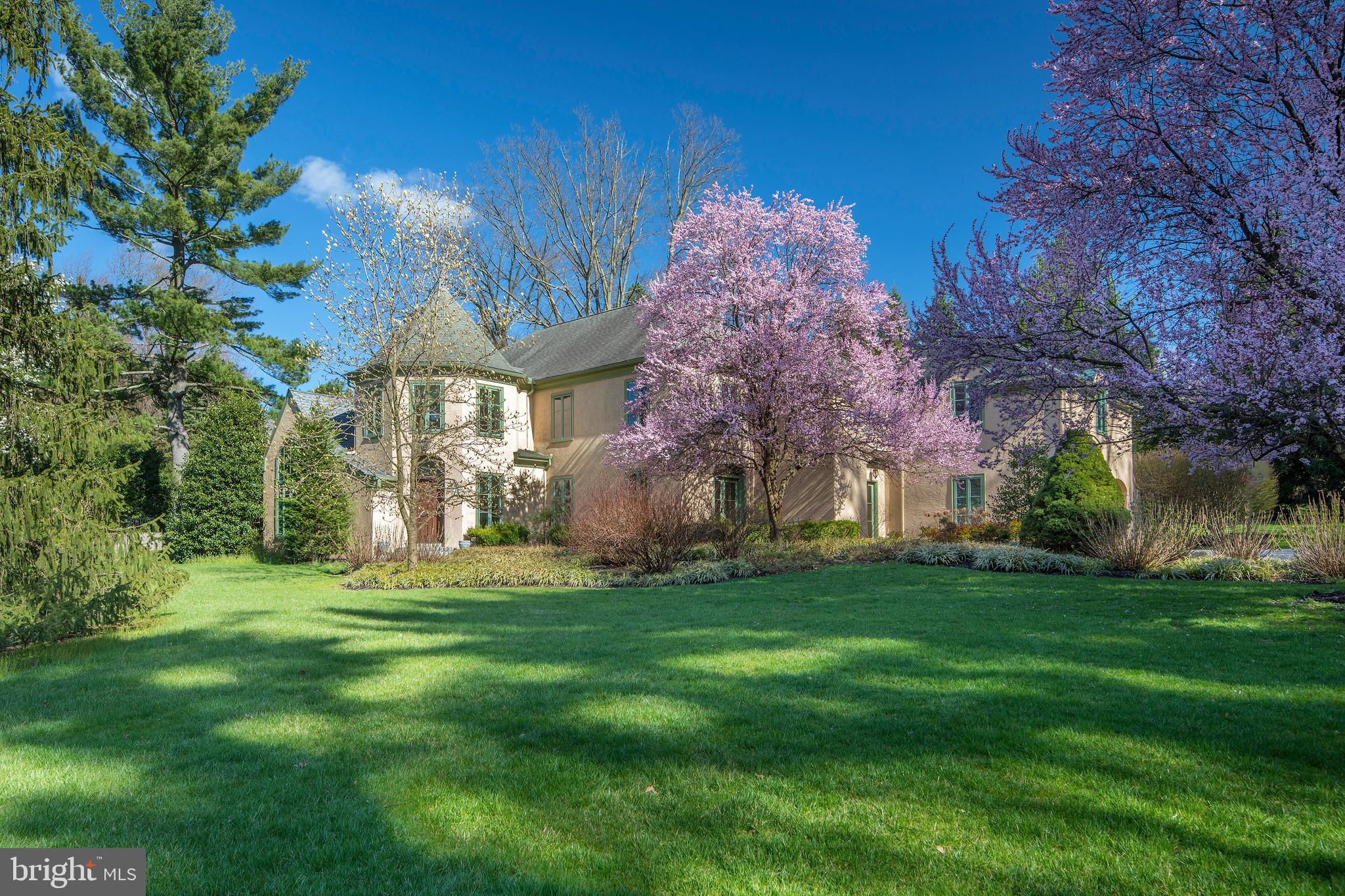 Move right into this sophisticated Main Line gem in a beautiful sought-after neighborhood of Radnor Twp., near all conveniences & excellent schools! This exquisitely-designed 5bedroom 3.1 bath European-inspired Manor home on .82 lush acres exudes elegance with its striking architecture & gorgeous details throughout. Classic charm & character meet modern living with an open floorplan plus recent upgrades such as all new Jeld-wen clad windows, fresh paint, new carpeting & thoughtful kitchen updates. This storybook home was built for style & comfort, affording a wonderful flow for both everyday family living & formal entertaining. Generously-sized rooms receive excellent natural light by day from the sun & even at night from the moon, especially in the master bedroom. The grand 2-story foyer with a sweeping main staircase receives you upon entry& leads to a center hall proceeding to large gracious living & dining rooms. Host a crowd in the huge living space featuring multiple seating options & a cast stone fireplace adding warmth. Adjacent is a vaulted library with built-in bookcases, decorative fireplace, wet bar &arch-topped window, ideal for cocktails, reading or relaxing. Celebrate holidays & special occasions in the large wainscoted dining room adorned with crown molding & French doors to scenic outdoor gardens. The cook will enjoy spending time in the open kitchen with new granite counters, new stainless steel sink & faucet, new Bosch dishwasher & new microwave. The sun-bathed breakfast area is perfect for coffee & casual fare, with glass doors to the rear flagstone patio oasis & gorgeous landscaped yard. Also open to the kitchen is the stunning, spacious family room enriched by a wood-burning fireplace. A mudroom with a glass-door side entrance connects the kitchen to the garage for conveniently transporting groceries from the car. Begin & end your day in serenity in your master suite accessed via a private hall. An enormous bedroom with tray ceiling & French doors to a Juliet balcony provides a sense of peace. Multiple closets including a big walk-in for belongings, and a white marble bath styled with dual vanities + an oversized shower with dual heads & frameless door complete the luxury experience. Also on this level are sizable secondary bedrooms, 2 full baths, an exercise room & bonus room with tray ceiling. Even more storage is provided with an attic &11 x6 cedar closet. Best of all is the scenic setting graced by privacy trees, lovelywalkways, patios & flowering gardens.