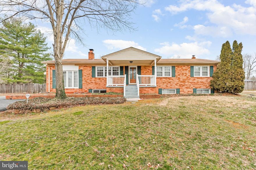 Featuring this gorgeous updated & remodeled 5 bedroom, 3 bath 2 level Brick Rambler situated on over an acre of level land.  Remodeled Gourmet kitchen with upgraded stainless steel appliances, custom cabinets with granite counter tops.  Stunning hardwood floors throughout the main level.  The lower level offers a large recreation room with brick a wood burning fireplace.  Two large bedrooms with new laminate floors.  A large separate  laundry room with plenty of storage and built in shelving.  The bonus room next to the kitchen was currently used as an office but could be easily converted into na large recreation room for game room.  The back yard is fully fenced with total privacy.  Offering a large enclosed covered screened porch off the kitchen.  You will also enjoy the covered car port.  This can be used as an additional two car port or covering for large parties and gatherings.  The driveway extends into the backyard and you have access to the two tiered two card detached garage.  Second level can be used for storage. Home warranty offered.