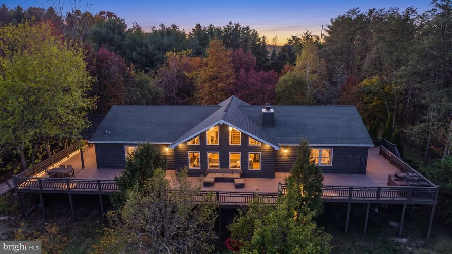 Lodge-Style Ranch on 76± Acres Bordering Potomac State Forest w/ Beautiful Mountain Views. 
Experience mountain living at its finest in this stunning lodge-style ranch home situated on 76± private acres bordering Potomac State Forest. With over 5,000 finished square feet, this 4-bedroom, 3-bathroom retreat offers the perfect blend of luxury, comfort, and outdoor adventure.
Recent updates and upgrades enhance the home’s appeal, while the expansive family room features soaring cathedral ceilings and dramatic atrium windows that frame breathtaking mountain views for miles. The fully finished lower level offers exceptional additional living space, including a large recreation room, two additional bedrooms, a full bath, and a private sauna room — ideal for relaxing after a day of exploring the surrounding state land. Step outside to the wraparound deck, complete with a hot tub overlooking a gorgeous mountain vista — the perfect setting for entertaining or unwinding in total privacy. A detached 30'x45'  garage provides ample space for vehicles, equipment, and off-road toys, making this property a dream base camp for outdoor enthusiasts. A rare opportunity to own a private mountain estate with direct access to Potomac State Forest — adventure truly begins at your doorstep.