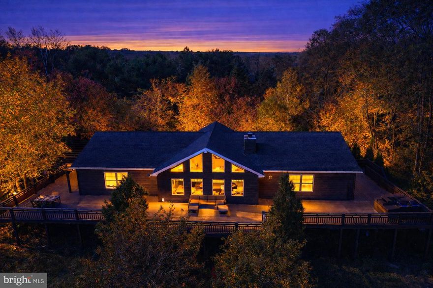 Lodge-Style Ranch on 76± Acres Bordering Potomac State Forest w/ Beautiful Mountain Views. 
Experience mountain living at its finest in this stunning lodge-style ranch home situated on 76± private acres bordering Potomac State Forest. With over 5,000 finished square feet, this 4-bedroom, 3-bathroom retreat offers the perfect blend of luxury, comfort, and outdoor adventure.
Recent updates and upgrades enhance the home’s appeal, while the expansive family room features soaring cathedral ceilings and dramatic atrium windows that frame breathtaking mountain views for miles. The fully finished lower level offers exceptional additional living space, including a large recreation room, two additional bedrooms, a full bath, and a private sauna room — ideal for relaxing after a day of exploring the surrounding state land. Step outside to the wraparound deck, complete with a hot tub overlooking a gorgeous mountain vista — the perfect setting for entertaining or unwinding in total privacy. A detached 30'x45'  garage provides ample space for vehicles, equipment, and off-road toys, making this property a dream base camp for outdoor enthusiasts. A rare opportunity to own a private mountain estate with direct access to Potomac State Forest — adventure truly begins at your doorstep.