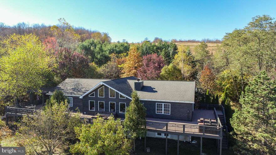 Lodge-Style Ranch on 76± Acres Bordering Potomac State Forest w/ Beautiful Mountain Views. 
Experience mountain living at its finest in this stunning lodge-style ranch home situated on 76± private acres bordering Potomac State Forest. With over 5,000 finished square feet, this 4-bedroom, 3-bathroom retreat offers the perfect blend of luxury, comfort, and outdoor adventure.
Recent updates and upgrades enhance the home’s appeal, while the expansive family room features soaring cathedral ceilings and dramatic atrium windows that frame breathtaking mountain views for miles. The fully finished lower level offers exceptional additional living space, including a large recreation room, two additional bedrooms, a full bath, and a private sauna room — ideal for relaxing after a day of exploring the surrounding state land. Step outside to the wraparound deck, complete with a hot tub overlooking a gorgeous mountain vista — the perfect setting for entertaining or unwinding in total privacy. A detached 30'x45'  garage provides ample space for vehicles, equipment, and off-road toys, making this property a dream base camp for outdoor enthusiasts. A rare opportunity to own a private mountain estate with direct access to Potomac State Forest — adventure truly begins at your doorstep.