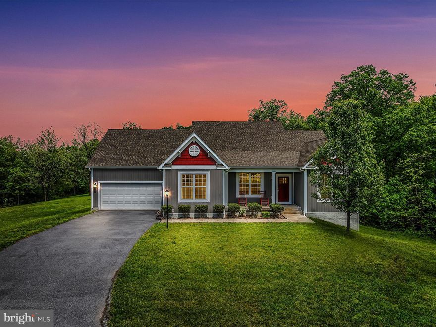 Remarkable home in a great location for easy access and close to Cacapon State Park.  Great open floor plan concept.  Gleaming hardwood floors, wood cabinets, granite counter tops and island.  A back deck facing the woods is another great feature.  Custom backsplash in the kitchen, master bedroom with master bathroom with walk in closet and double vanities are featured.  Master bath has a shower and soaking tub.  Extra length garage for more storage.  Central heat and air for comfort and vaulted ceilings are other nice touches. Full basement with rough in plumbing for a bath and walk out to exterior feature. A must see!!