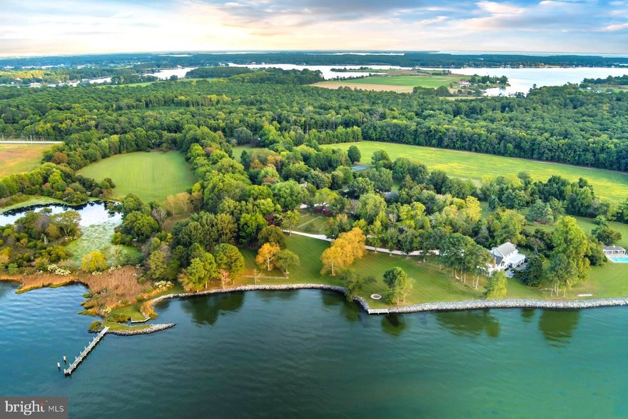 "Bolton Farm", available for the first time in over two decades, is an exceptional offering of rare privacy, including a renovated manner house, historic guest house, new four stall horse barn, pool and tennis.  Originally known as Quaker Kemp Farm, dating back to 1790, this remarkable 115-acre waterfront estate with two deeded lots has breathtaking western views across the Chesapeake Bay. A gated entrance and mature tree-lined drive create a gracious approach to the main residence while highlighting the property’s stunning water views, natural beauty with mature landscaping and specimen trees. 

The generous porch front manor house blends classic architecture with relaxed coastal style with newly updated kitchen and baths.  The expansive waterside living room features brick flooring and floor-to-ceiling windows and French doors that flood the space with natural light and showcase stunning water views. A formal living room and dining room sit adjacent, seamlessly connecting the rooms.   The well-appointed kitchen and family rooms include a large center island, breakfast area, wet bar, high-end stainless appliances, built-ins and fireplace. A waterside screened porch extends the living space outdoors, perfect for dining and relaxation. The main floor also offers a guest or owners suite with an en-suite marble bath. The paneled mudroom and powder room complete this floor. 

Upstairs, the hall landing provides access to the generous primary suite which includes built-ins and a beautifully appointed en-suite marble bath. Two additional bedrooms are connected by a renovated bath.  The oversized fourth bedroom suite includes a sitting room, en-suite bath and stunning views.  This floor is completed with a laundry room.  The third floor provides two additional guest bedrooms and a shared full bath.  The lower-level basement offers excellent storage.  

The charming brick guest house, circa, 1790 has two-bedrooms featuring a new cedar shake roof, center hall, high ceilings, wood floors, moldings, full kitchen and renovated bath.  
 

The Equestrian and agricultural amenities include a new four-stall barn with loft game room, fenced pastures, a wooded forest, two equipment barns, and a greenhouse/garden shed. Meandering paths connect the main house, guest house, and barns. The property includes a parcel across from the main entrance to ensure additional privacy.  

The outdoor features give the farm the opportunity for large family occasions with numerous areas to gather and enjoy the stunning sunsets.  Features include a waterside pool, covered pavilion, private tennis court, two ponds, a pier and hiking trails throughout the expansive grounds.  
 
An adjacent 37+-acre waterfront parcel (included in the total acreage) has a sandy beach and offers additional opportunity, with approvals in place for a seven-bedroom main residence and a three-bedroom guest house. 
 
With nearly 4,000 feet of riprapped shoreline, “Bolton Farm” represents a rare offering on Maryland’s Eastern Shore.