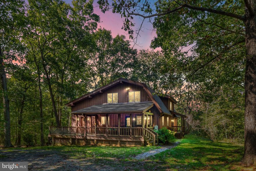 A pleasant, yet short, country ride along the paved portion of Telegraph Springs brings you to Hunting Hill.  The privacy of over 16 wooded acres is the perfect setting for living the dream.  It's far enough away, yet easy to live in and close to Purcellville.  This uniquely custom country home features a large main level bedroom with attached full bath, a large "eat in" kitchen, formal dining room, and a generous foyer leading to the 2 story living room/sunroom which opens to a deck overlooking the forest.  The upper level overlooks the main level living and here you'll find another generously sized bedroom attached to another shared full bath.  Two additional bedrooms occupy the opposite end of the upper level.  The full walkout basement offers the convenience of another full bath, an enormous rec room, 2nd kitchen/laundry, and two organized storage rooms.  This walkout basement could easily work as an au pair or perhaps a mother in law suite.
To label the detached additional structure as a garage just isn't going to do it justice.  The building is roughed in for a bath and has over 2300 square feet.  The car parking area alone is 864 square feet plus there's a 600 square foot shop attached behind the parking area that was designed for woodworking.  On the 2nd level of this structure is a wide open 36x24 room suitable for all sorts of things.  This structure also has a dedicated independent 200 amp electric service.  Call today for a private tour.