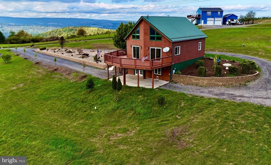 DRAMATIC WINDOWS SOAR TO THE PEAK OF THIS UNIQUE 2,700 SF CHALET W CEDAR SIDING, VINYL CLAD WINDOWS, STORM DOORS, 2-CAR DET GARAGE W OVERHEAD STUDIO PERCHED ON 3.69 ACS W BREATHTAKING VIEWS OF JENNINGS RANDOLPH LAKE.  THE OVERSIZED WINDOWS FLOOD THE OPEN LIVING, DINING AND KITCHEN AREAS. WARM NATURAL LIGHT. SPACIOUS LIVING RM W FABULOUS 20’ VAULTED CEILING, WOOD FLOORS & 2 SLIDING GLASS DOORS LEADING TO MASSIVE 16’ X 28’ DECK. COZY KITCHEN INCLUDE ALL APPLIANCES.  TWO BEDROOMS AND ONE FULL BATH ON MAIN LEVEL.  LOFT AREA.  MASTER BEDROOM W FULL BATH, 10½’ CEILING. ACCESS TO FULL BASEMENT PROVIDES A VERSATILE RECREATION/FAMILY RM, FULL BATH, STORAGE ROOM, UTILITY ROOM AND ADDITIONAL BEDROOM. NEW HIGHLY EFFICIENT ENERGY HEAT PUMP W MINI-SPLITS INSTALLED.   NEARBY RECREATIONAL AMENITIES: FULL SIZE REC LAKE W PUBLIC BOAT LAUNCH, CAMPGROUNDS, PICNIC PAVILIONS, SCENIC OVERLOOK & NEW SWIMMING BEACH, 2 NATURE TRAILS, WORLD CLASS TROUT FISHING, BIG GAME HUNTING (WMA – 6,000 ACRES) WHITE-WATER RAFTING.  ONLY 2 ½ HRS METRO. PLAT OF SURVEY ON REVERSE SIDE.   ($300 ANNUAL RD MAINTENANCE FEES.)  NEW WELL INSTALLED 5/20/24.    CALL AGENT FOR MORE DETAILS AND DIRECTIONS. CALL FOR SPEC SHEET.