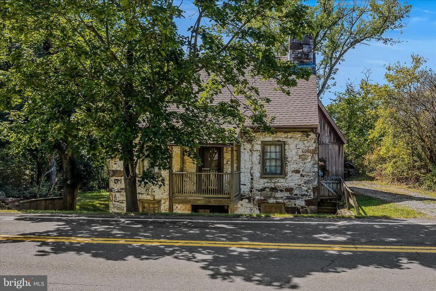 Welcome to The Tanyard House, Step Back in Time with Modern Comfort.
Steeped in nearly three centuries of history, The Tanyard House is one of Gerrardstown’s most treasured landmarks, built circa 1740 of hand-laid stone and timber and featured on the House & Garden Tour for its unmatched charm and craftsmanship. Once part of the village’s early leather-working commerce that inspired its name, this home is a rare living piece of West Virginia history.
Inside, the past meets the present in unforgettable ways:
Three wood-burning fireplaces and exposed chestnut beams create a warm, authentic atmosphere.
A clawfoot soaking tub, rich woodwork, and a walk-in kitchen hearth speak to the home’s 18th-century origins, while thoughtful updates ensure ease of living.
2 bedrooms, 1.5 baths, and a detached building with a laundry room provide both cozy comfort and practical space.
Modern upgrades bring peace of mind without compromising character such as, new furnace and central AC installed within the last five years, new hot water heater (2022) and new roof (2024).
Outdoors, a meandering creek wraps around the property, offering serene views and a natural soundtrack. Although flood insurance is required, the property has never flooded in 25 years of ownership, making it a secure and scenic haven.  The concrete retaining wall faced with brick adds lasting value.
Whether envisioned as a private retreat, artist’s hideaway, or boutique AirBnB, The Tanyard House is a one-of-a-kind opportunity to own a genuine slice of West Virginia history, where 18th-century craftsmanship and 21st-century comfort meet in perfect harmony.