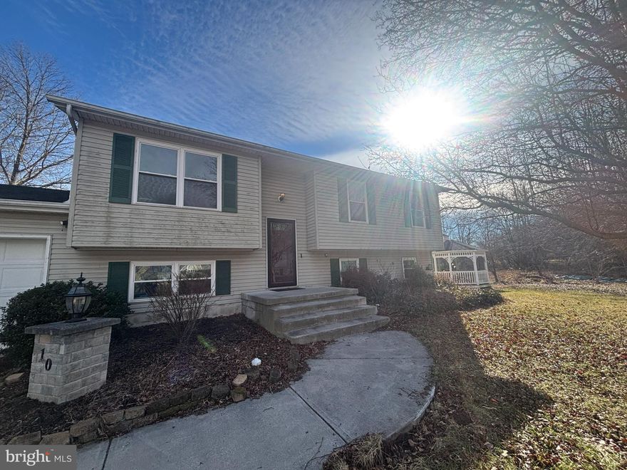 This 4-bedroom, 3–full-bath split foyer is located in the quiet Windy Hills neighborhood and positioned toward the rear of the subdivision, offering a more private setting. The property is being sold strictly as-is, providing an opportunity for a buyer ready to update and make it their own. The main level features three bedrooms, including one with a private en suite bath, plus an additional hall bath. The lower level includes a fourth bedroom with a walk-in closet and a full bath with jetted tub, offering flexible space for guests, hobbies, or extended living. The home offers a large kitchen with granite countertops, providing a solid starting point for future updates. Washer and dryer hookups are present in the utility room. The air handler and compressor require replacement; units are located in the garage and have not been installed. The roof is approximately 6 years old (seller makes no warranty). Outdoor highlights include a fenced backyard backing to open space, along with a concrete patio and gazebo, creating room to enjoy the outdoors. Convenient to town amenities. Buyer to verify property condition, utilities, permits, zoning, schools, and intended use.