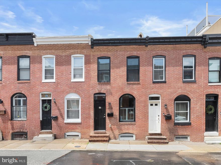 Introducing a beautifully updated 3-bedroom, 3.5-bathroom row home where classic charm and contemporary style blend seamlessly. The open-concept main level features a fresh neutral palette, rich hardwood floors, and striking exposed brick walls that add warmth and character. The inviting living room, enhanced by crown molding, flows effortlessly into the dining area—perfect for both everyday living and entertaining. Your culinary skills will shine in the gourmet eat-in kitchen, complete with stainless steel appliances, gleaming quartz countertops, a waterfall center island accented by pendant lighting, and a decorative tile backsplash. A stylish powder room and direct access to the rear parking pad add convenience to this thoughtfully designed space.  Upstairs, the serene sleeping quarters include a primary suite with an updated en suite bathroom featuring a walk-in shower with frameless glass doors. This level also offers a second bedroom, a full bath, a laundry area, and access to a stunning rooftop deck—ideal for relaxing or entertaining with skyline views.  The finished lower level provides a third bedroom, an additional full bath, and a versatile bonus room—perfect for a home office, gym, or creative space.  With the updates, location, and the 4 years remaining on the CHAP tax credit, this home has it all! Situated in the heart of vibrant Canton, this home offers easy access to top-rated dining, shopping, and major commuter routes. A true gem that combines modern comforts with timeless appeal.