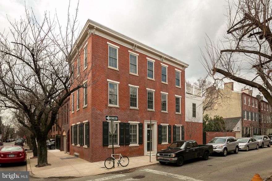 This elegant, historic home is located on the quiet corner of American Street and Monroe Street in Queen Village.  A/K/A 730 S. American Street. An oasis in the city. The light is exceptional, thanks to large windows and north, south and east exposures.  There are beautiful views of historic homes and gardens, plus a lovely landscaped garden  and 1 car GARAGE. This unique home was completely rebuilt and beautifully renovated in 2006-2007. It is in meticulous condition. It combines the best of old and new, with high ceilings, floor moldings, coffered  LR ceiling, wood floors throughout, French doors, custom cabinetry, recessed lighting and an exquisitely crafted stairway. The three story addition was added to create a new Master Bedroom on the 2nd floor, enlarge the living room and add a sun deck.  There are 4 large bedrooms, 3 1/2 baths, study/office and finished basement.  Square footage is 2905.  A list of improvements is attached to SPD. Entry leads to a large, beautiful proportioned Living Room with marble Fireplace, extensive cabinetry, and bay wall of French doors and windows, which lead to the brick garden with mature trees and planting beds.  Large corner dining room with granite topped bar and storage. Cook's kitchen with generous storage, granite counters and breakfast bar. Bosch d/w, Subzero refrigerator, gas cooking,  garbage disposal, Powder Room and double coat closet.  Stairway up to study/office, with built-in desk and cabinets. Large master bedroom with large bay window overlooks the garden. Elegant master bath with double sinks, double glass and marble shower and large closets.  Large corner bedroom,: lovely en-suite bathroom with marble topped vanity and Laundry.  3rd floor: 2 large bedrooms and expansive tiled hall bath.  Small sitting room leads out to huge sun deck. Large lower level den/study with additional closets and storage space.  2 zoned  HVAC, Security System.