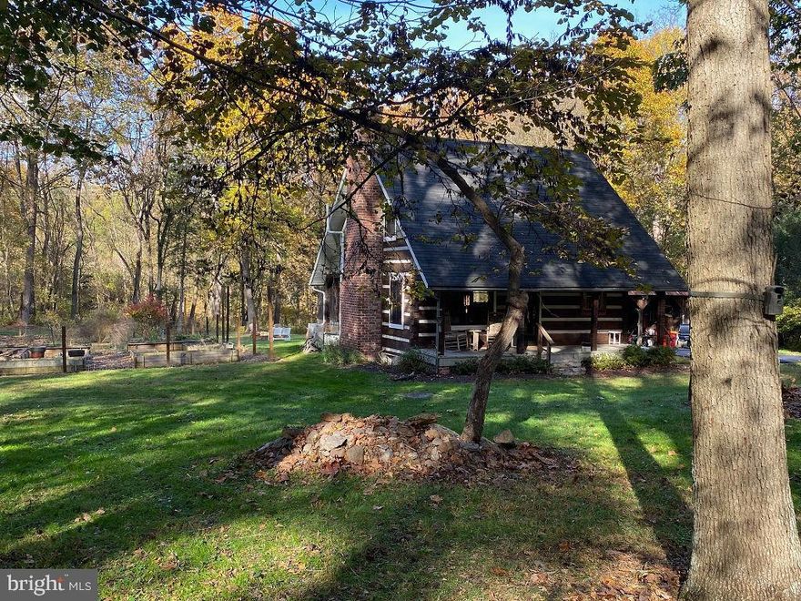 Highest and best due by 5:00 PM February 5th. Get ready for this! This home is a must-see if you're looking for a unique, secluded, rural property with features like a garden, barn, bunkhouse/studio, or all of the above. It's a rare gem on 12.46 acres surrounded by woods, yet it boasts a beautiful yard. The property includes a second dwelling currently used as an art studio—fully heated and air-conditioned, offering versatile possibilities. The main house is a modern log cabin, tastefully done, with the primary bedroom on the second level featuring a private full bath. The main level includes a living room area, dining area, kitchen with an island, a half bath, and a cozy wood stove. The lower level serves as additional living space/ bedroom with an easy-open Murphy bed, another full bath, laundry, and a utility sink. The basement has both an outside entrance and inside stairs. The property also features a barn with upper and lower levels for equipment storage or work shop, a fenced garden area with raised beds for growing vegetables, and a third detached building with parking for two cars, a large tool storage area, and a firewood storage space. This home, located in the historic area of Sharpsburg, is only minutes away from historic Boonsboro, Crystal Grottos Caverns, Antietam Battlefield, Maryland Ag Center, Potomac River, C & O Canal, and Historic Shepherdstown, WV. The Canal and Potomac River are just 1.5 miles away—an easy bike ride. Interstate 70 is a mere 13-minute drive and Interstate 81-10 minutes.  Notably, the property boasts the largest Chinkapin Oak Tree in Maryland. Abundant wildlife including deer and turkey’s surround the property, as seen in the photos.  Check out all the photos and contact your agent or me to set up your showing ASAP. You have to see this place!