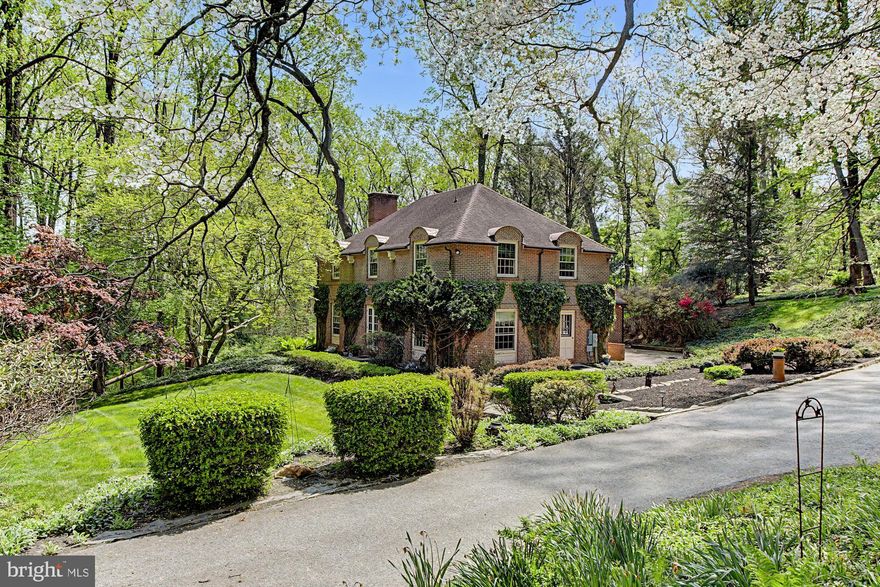 Nestled in a rarely available neighborhood in the Falls Road Corridor, this 1967 French-Eclectic residence offers timeless charm, in a serene, nature-filled setting. Positioned near the end of the road, with minimal through traffic, the home enjoys exceptional privacy, surrounded by wooded views on just under 1.5 acres of manicured grounds.
A picturesque exterior showcases classic brick complemented by climbing ivy, blending seamlessly into its natural surrounding. Inside, the home features four spacious bedrooms, two full baths and one half bath.  The main level includes an eat-in kitchen with breakfast area, a welcoming family room with skylights and a wood-burning  fireplace, a living room with second  fireplace, and a separate dining room suited for everyday living and entertaining. 
Upstairs, you'll find three well-appointed bedrooms and a  full bath, along with a private, primary suite complete with its own full bath offering a comfortable and functional layout.
This peaceful setting feels like a world away, yet remains incredibly convenient to everyday amenities, including Greenspring Station, shopping, dining and major commuter routes (I-695 and I-83). Additional highlights include a whole-house Generac generator (installed last summer) providing added reliability. A one year home warranty conveys with the property.
An exceptional opportunity in a sought-after location. Schedule your private showing today.